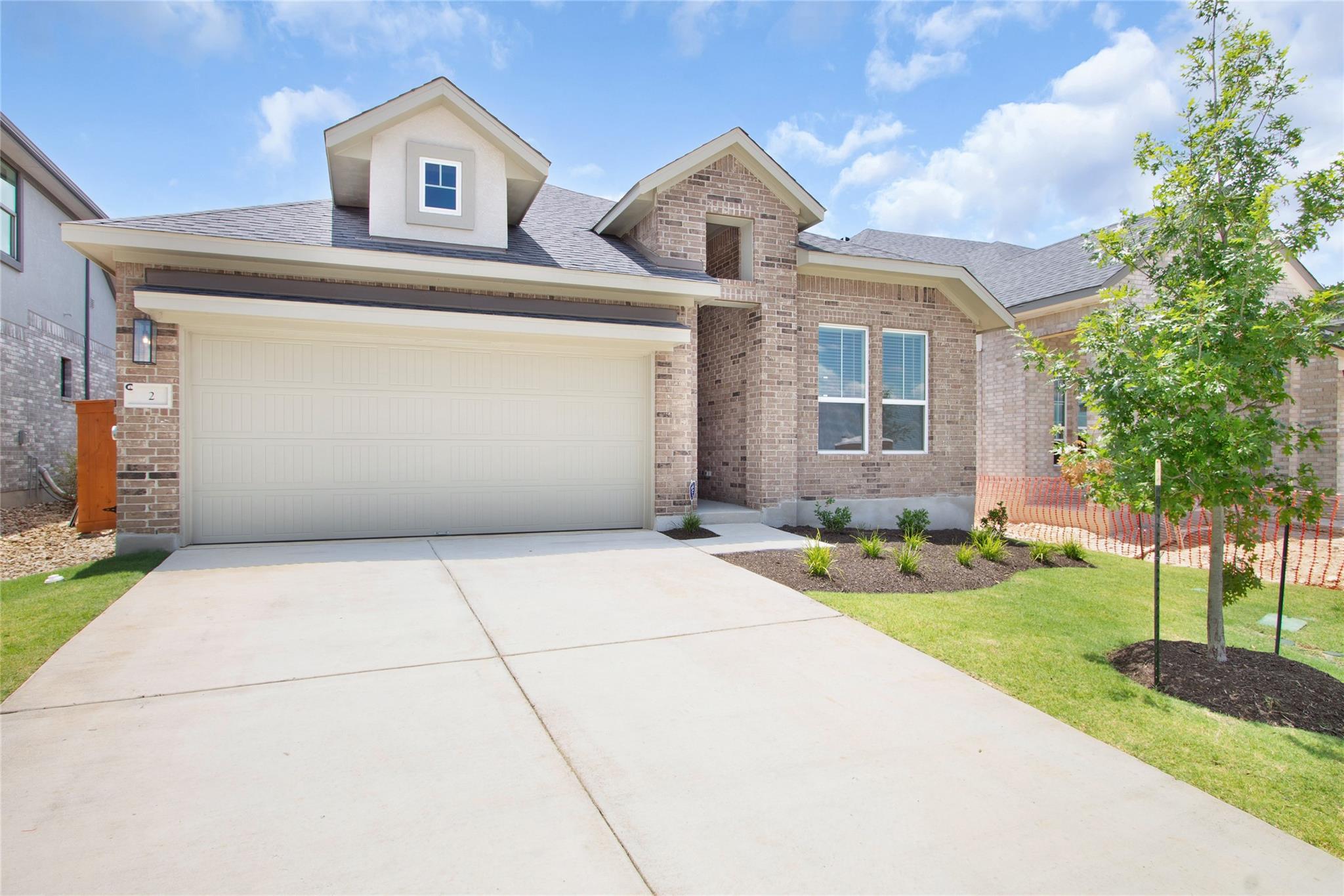 A newly constructed brick home with a spacious co