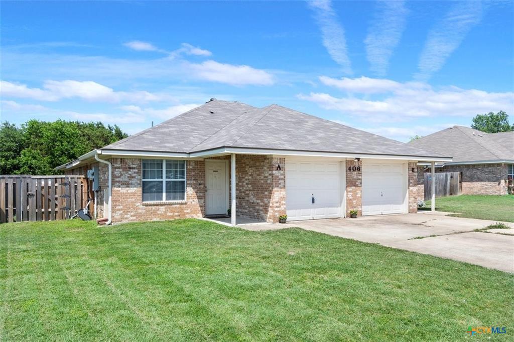 A well-kept front yard offers welcoming curb appe