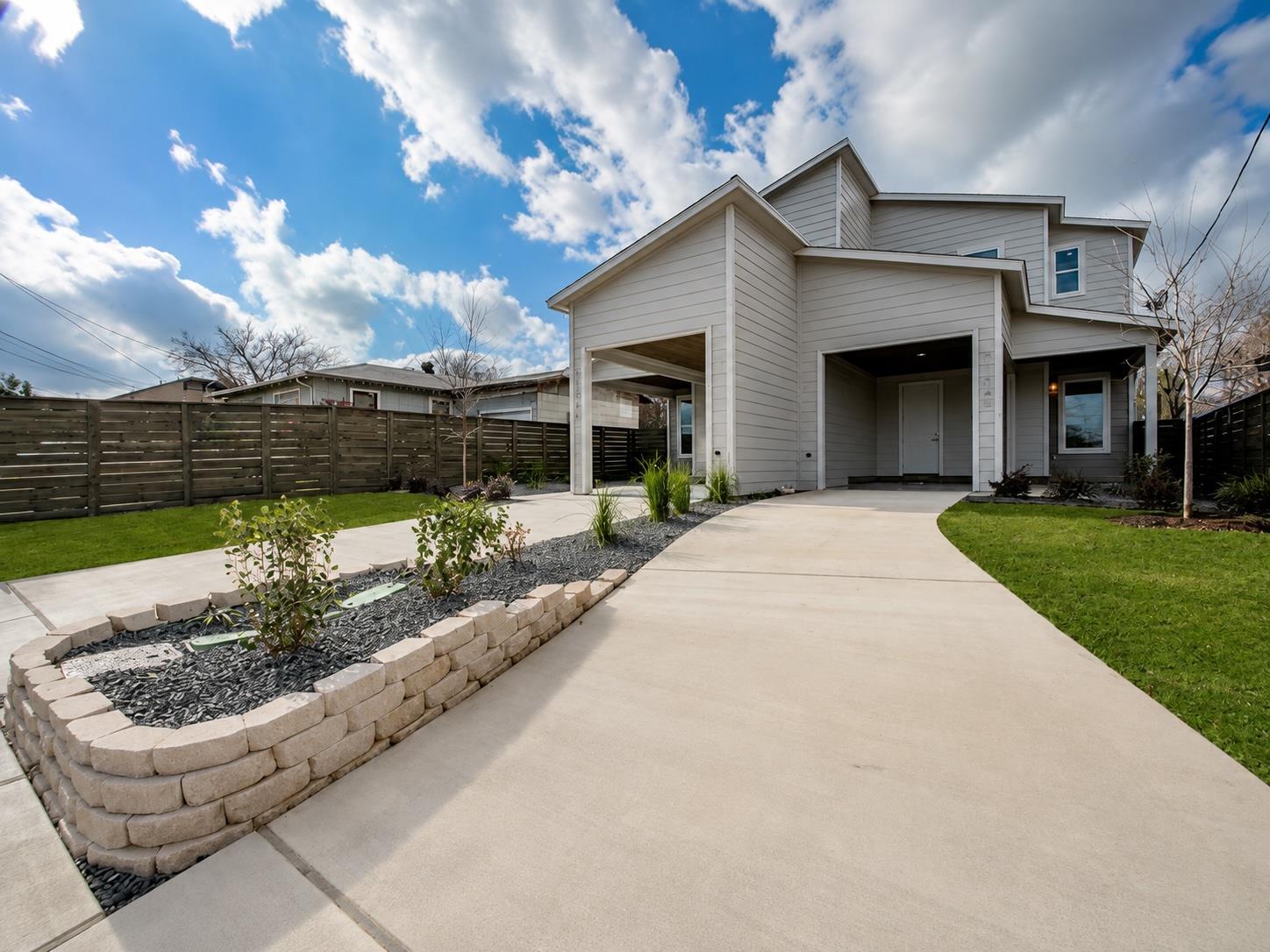 A contemporary exterior welcomes with covered par