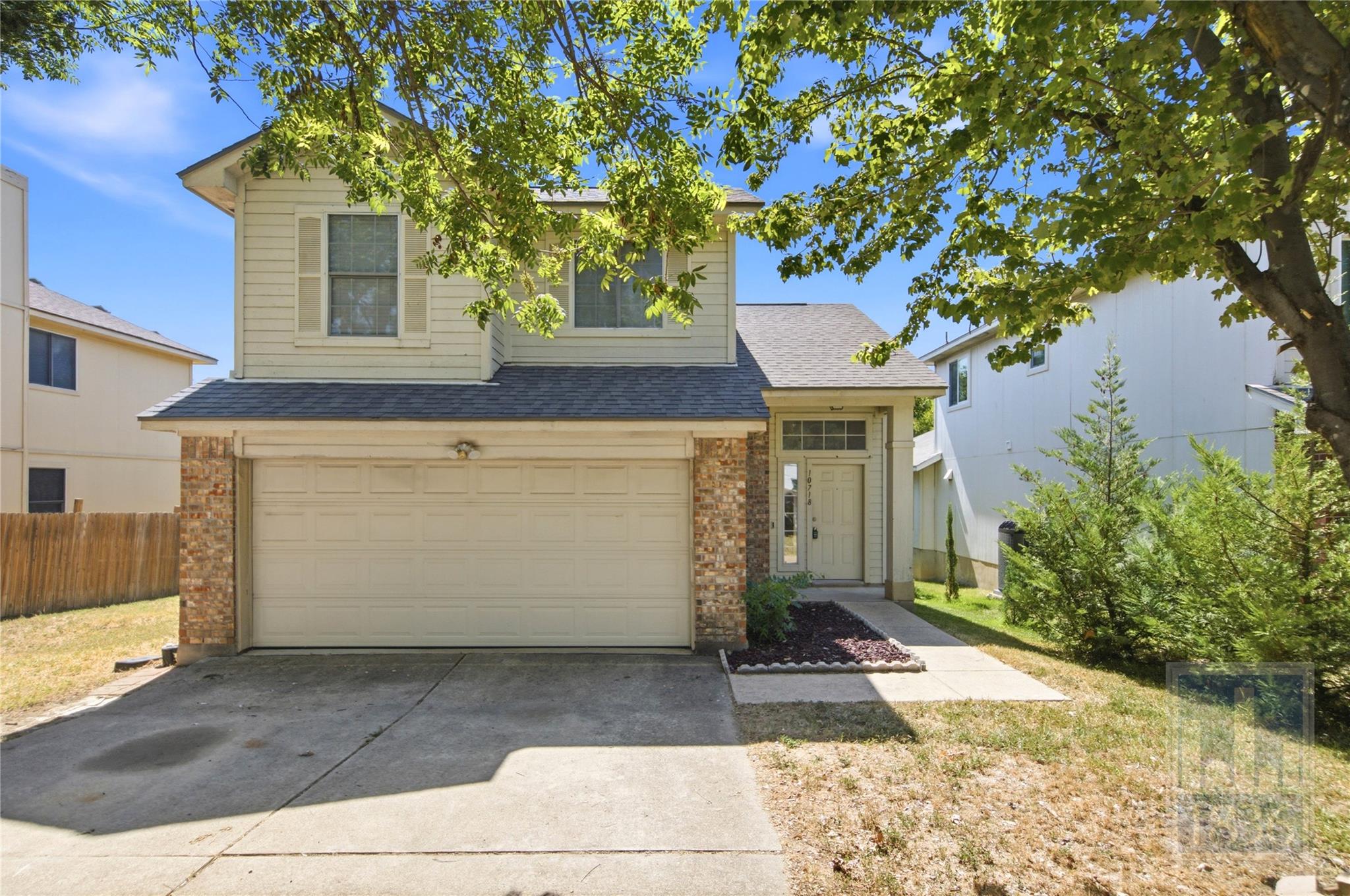 Mature trees shade a classic two-story exterior f