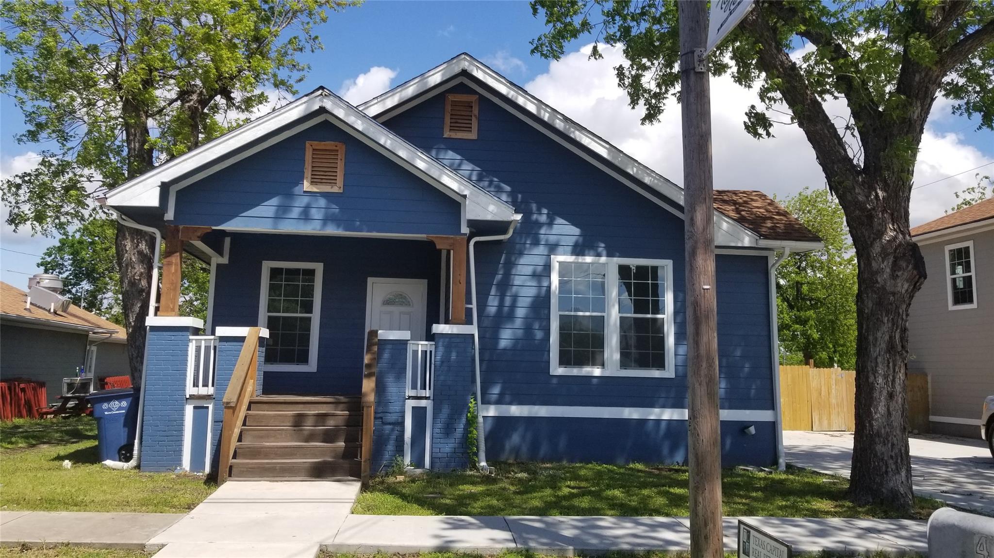 A charming blue residence with a welcoming front 