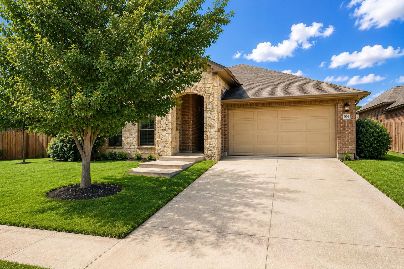 A well-maintained lawn and mature tree enhance th