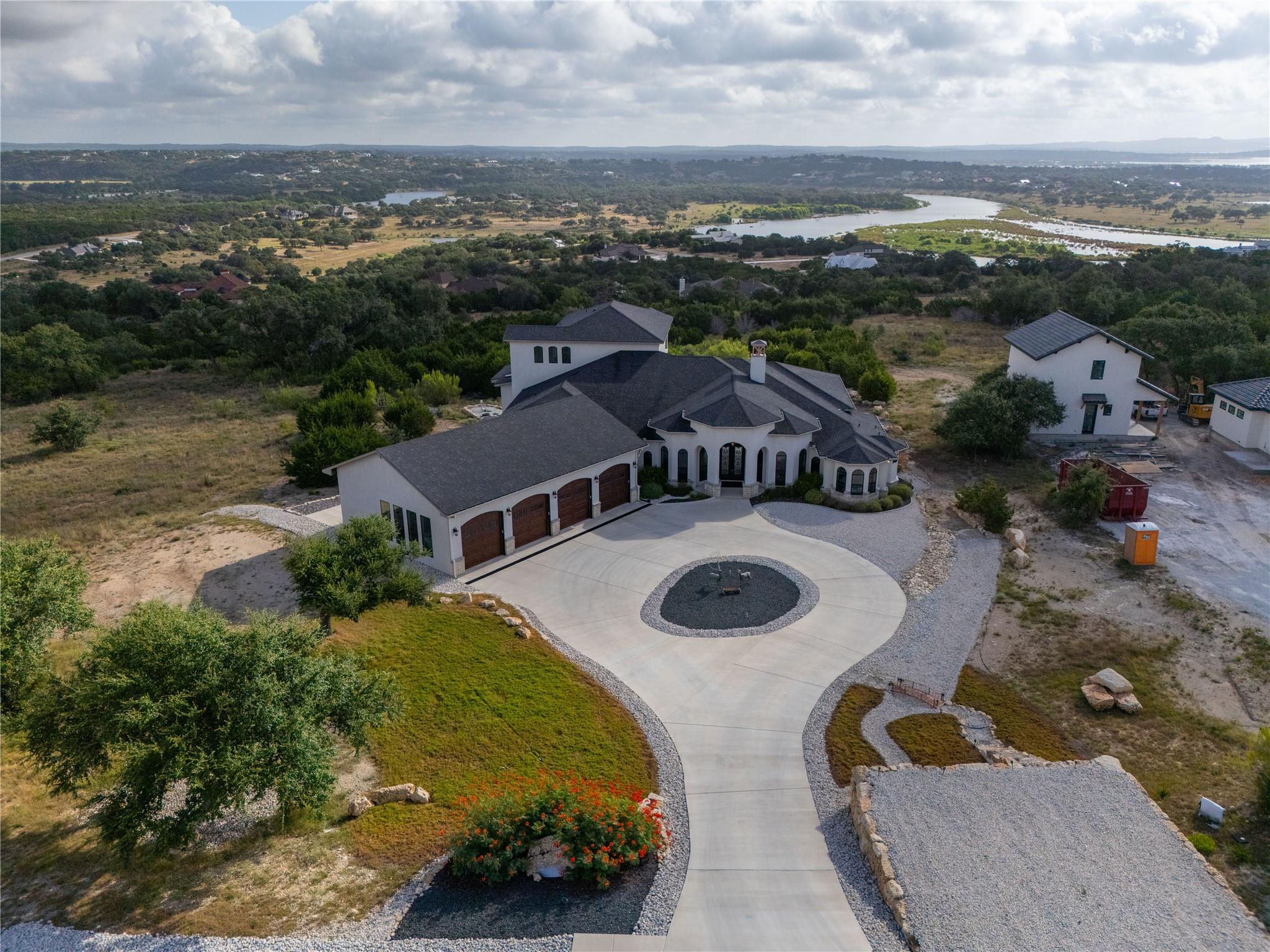 An elegant circular driveway leads to a classic c