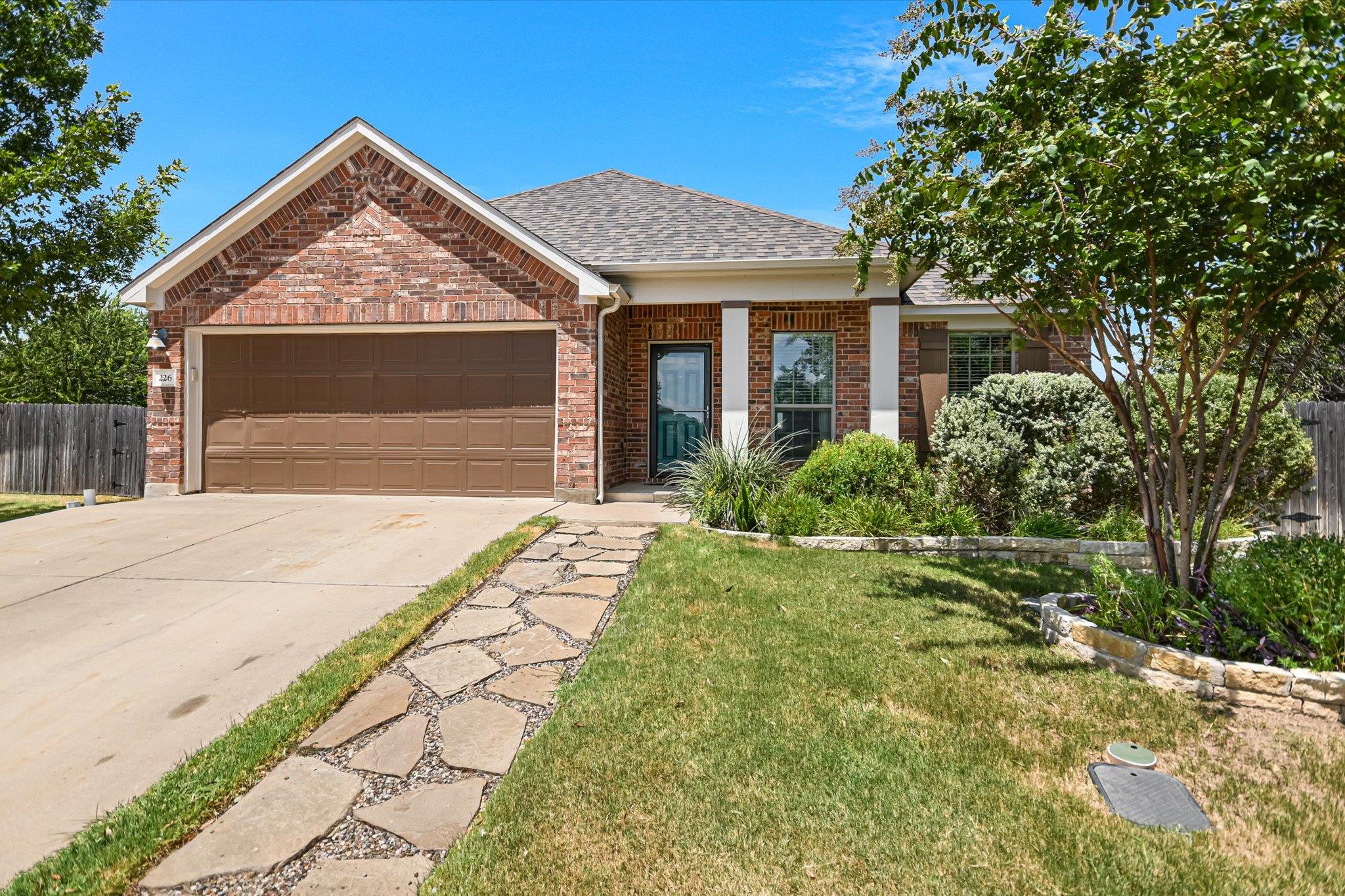 Classic brick exterior and manicured landscaping 
