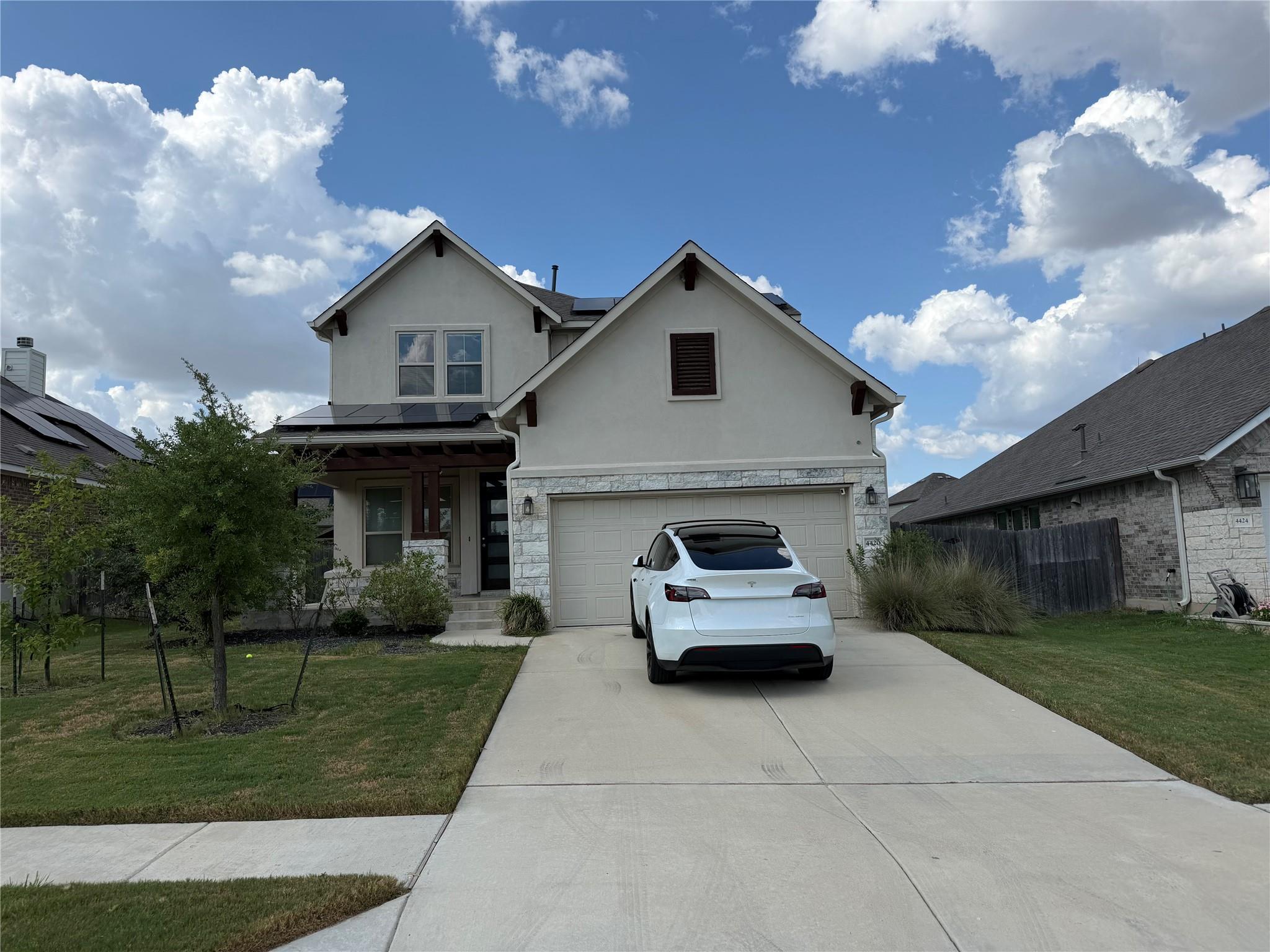 A well-maintained lawn and extended driveway gree