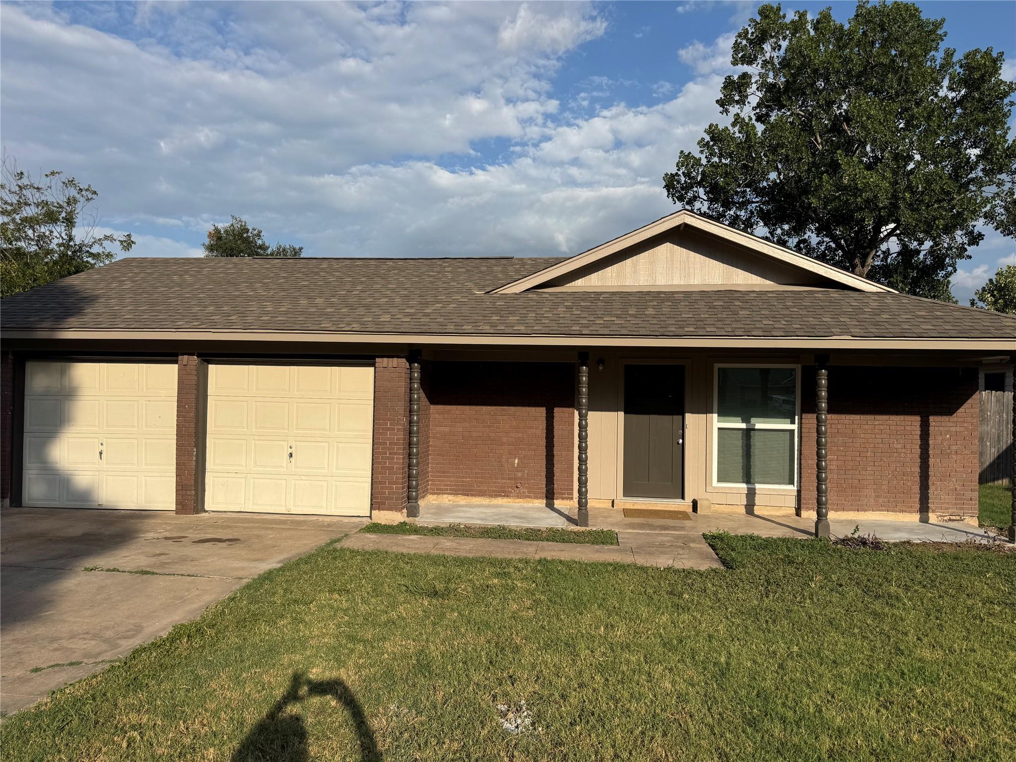 A classic brick exterior with a two-car garage an
