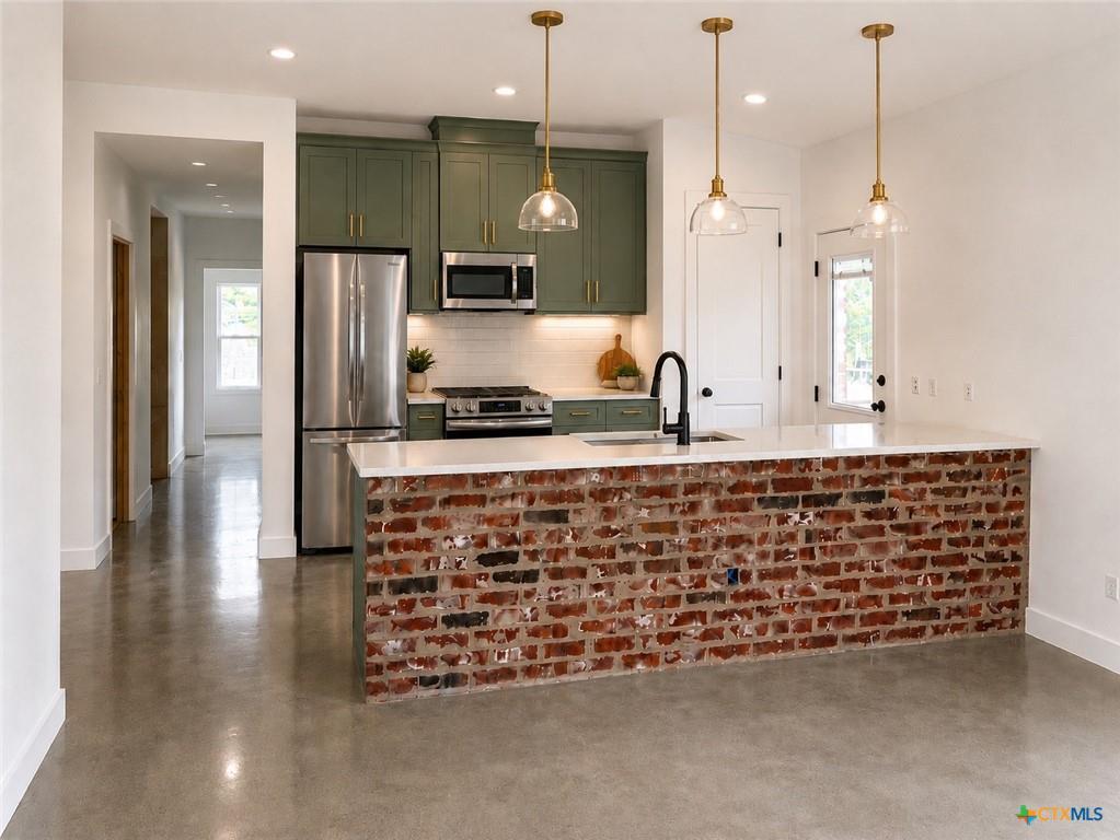 A contemporary kitchen features sleek green cabin