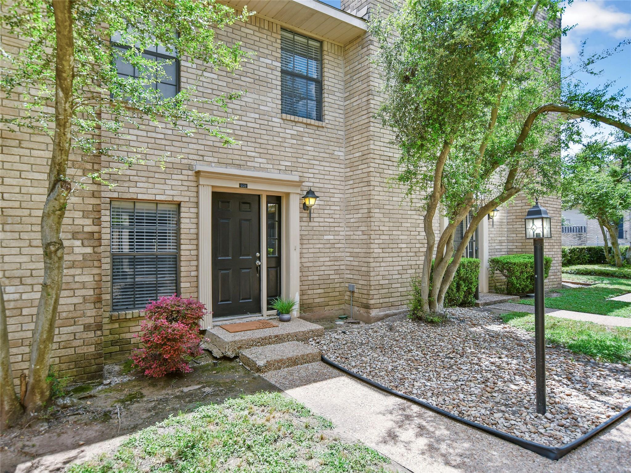 An inviting stone-paved entryway leads directly t