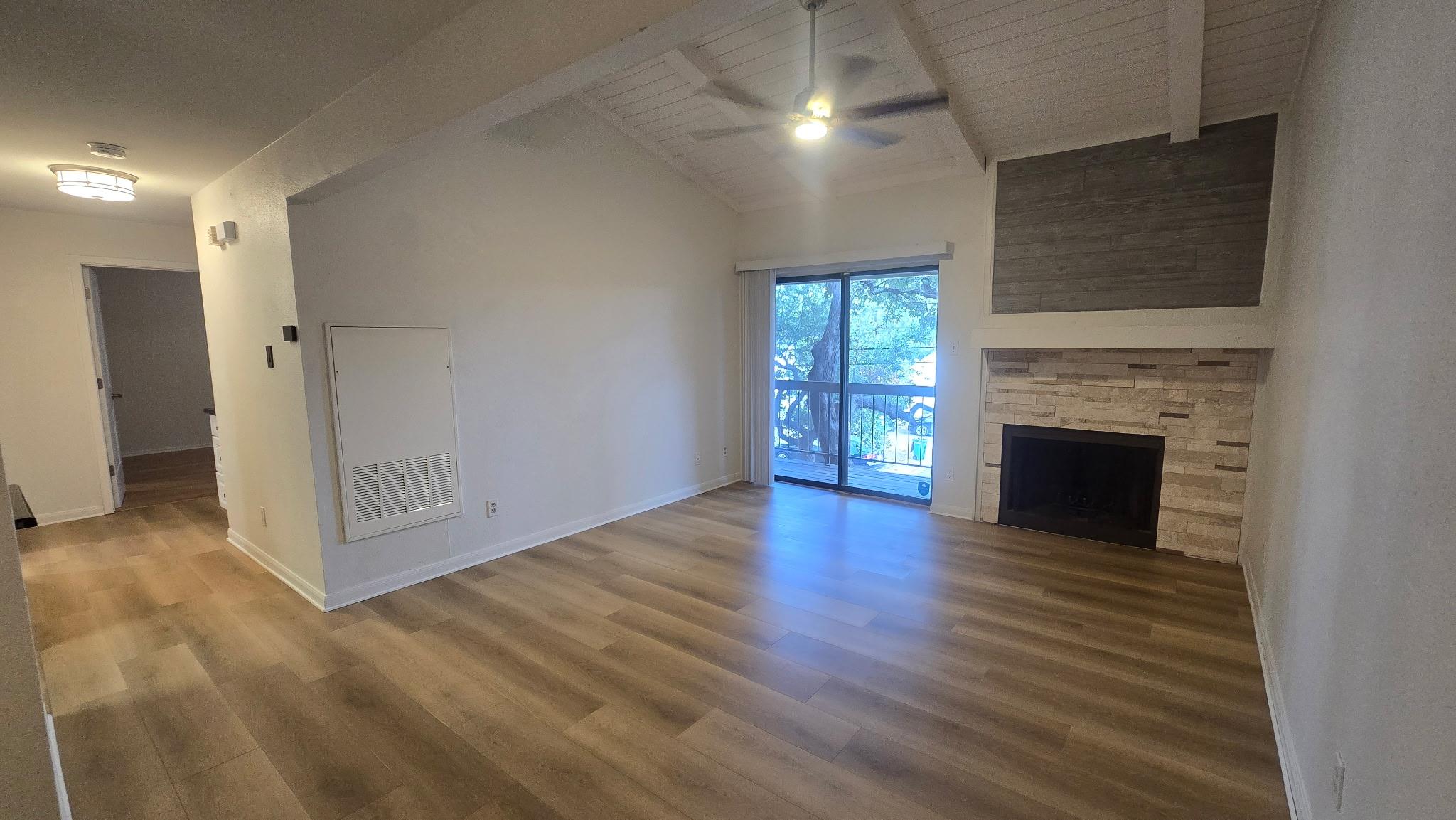 A stone fireplace anchors the living space under 