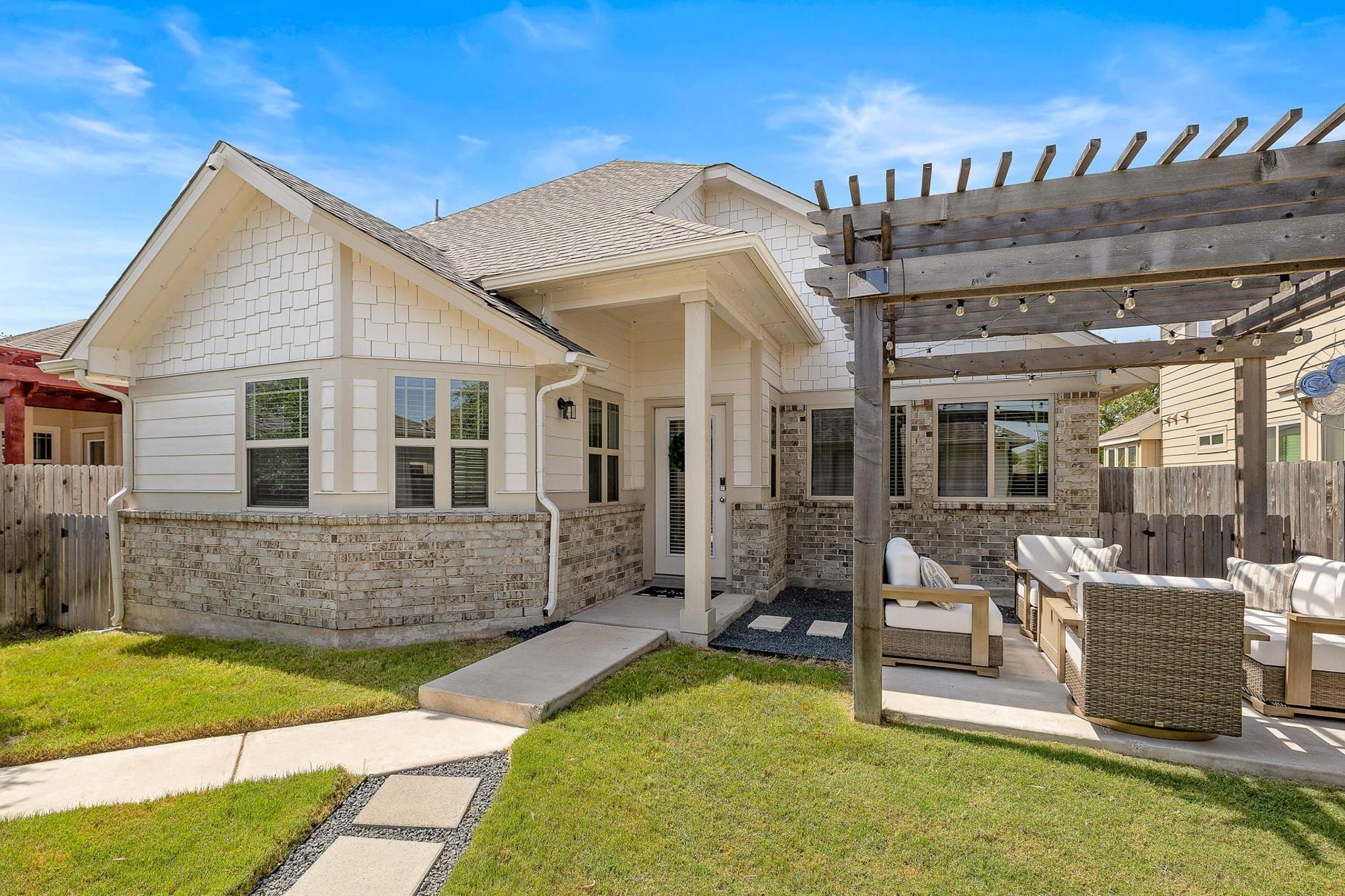 An inviting stone-accented facade gives way to a 