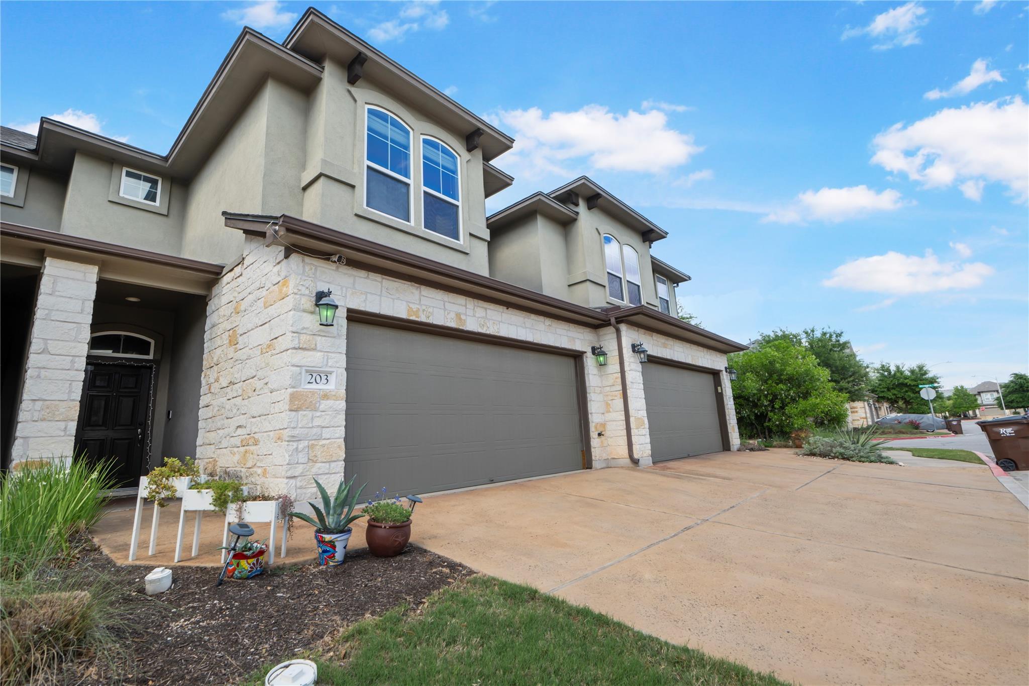 Multi-level stone and stucco townhomes feature sp