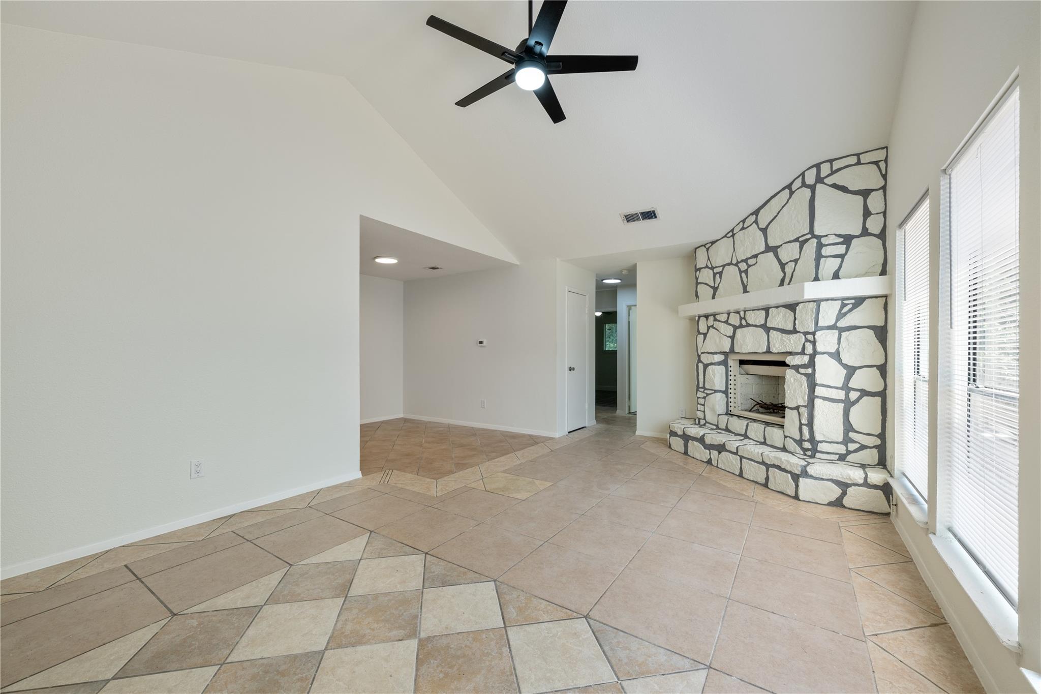 A spacious living area featuring a striking stone