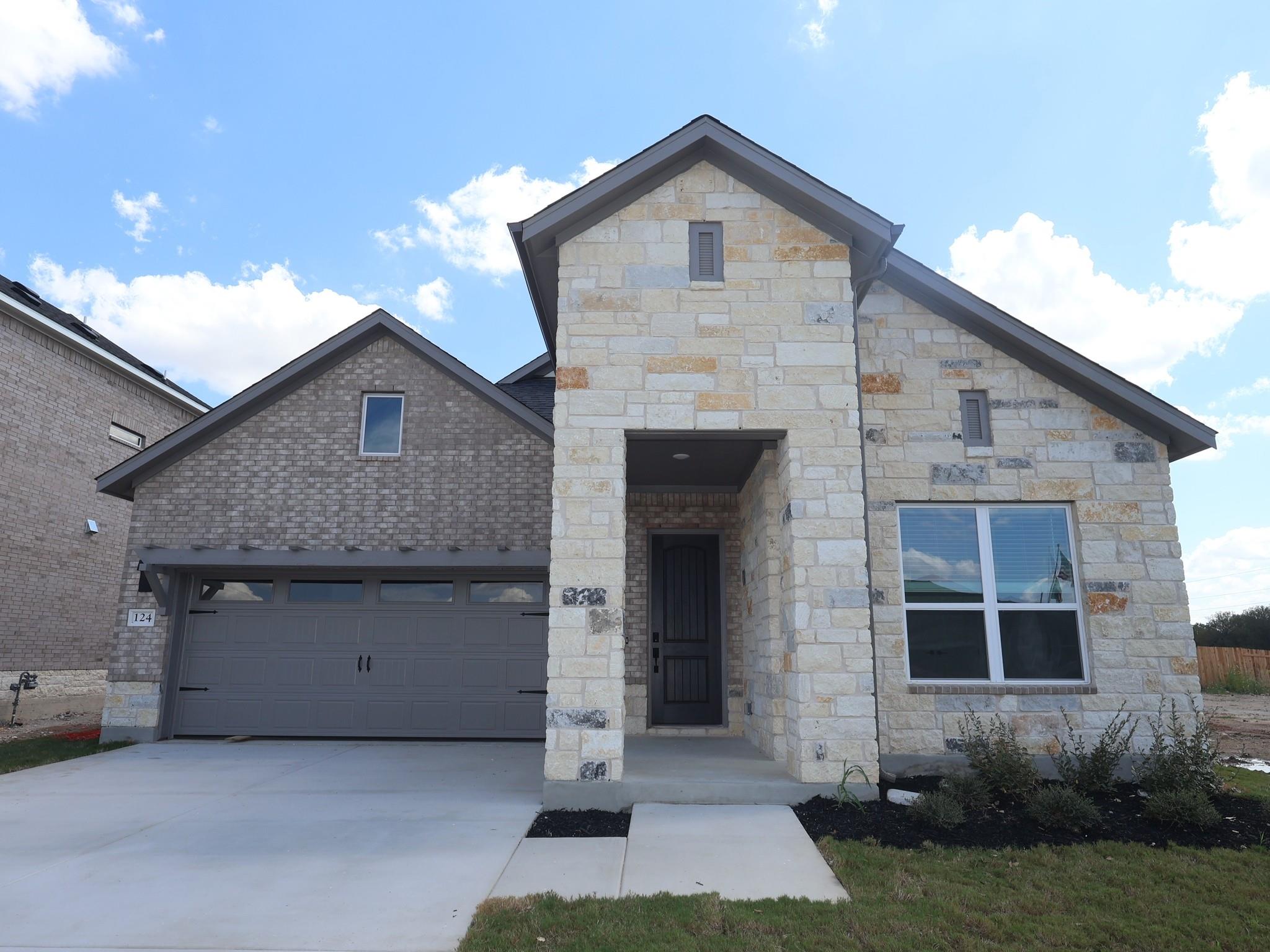Textured stone veneer and neat brickwork define t