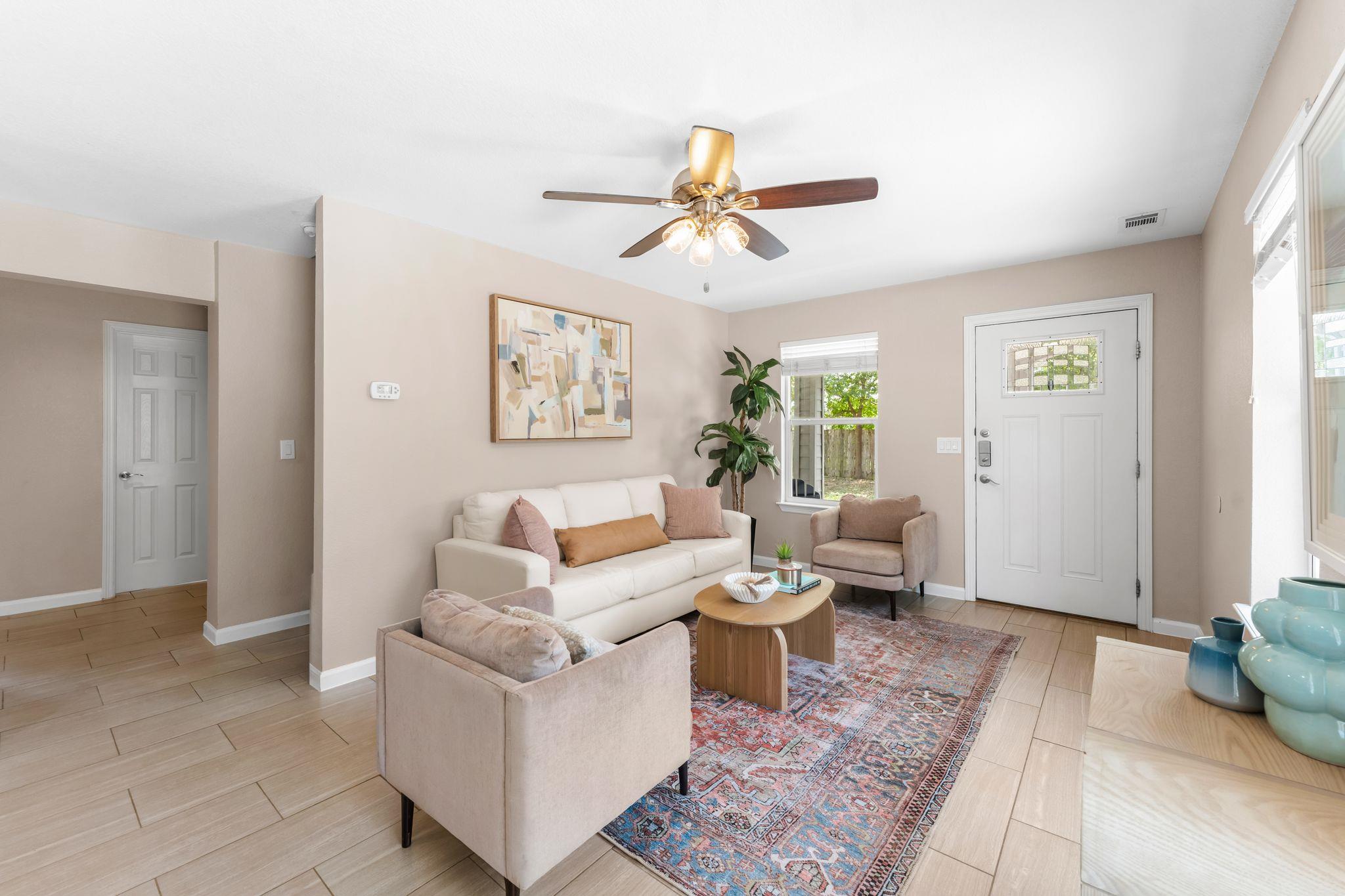 A welcoming living area boasts durable tile floor