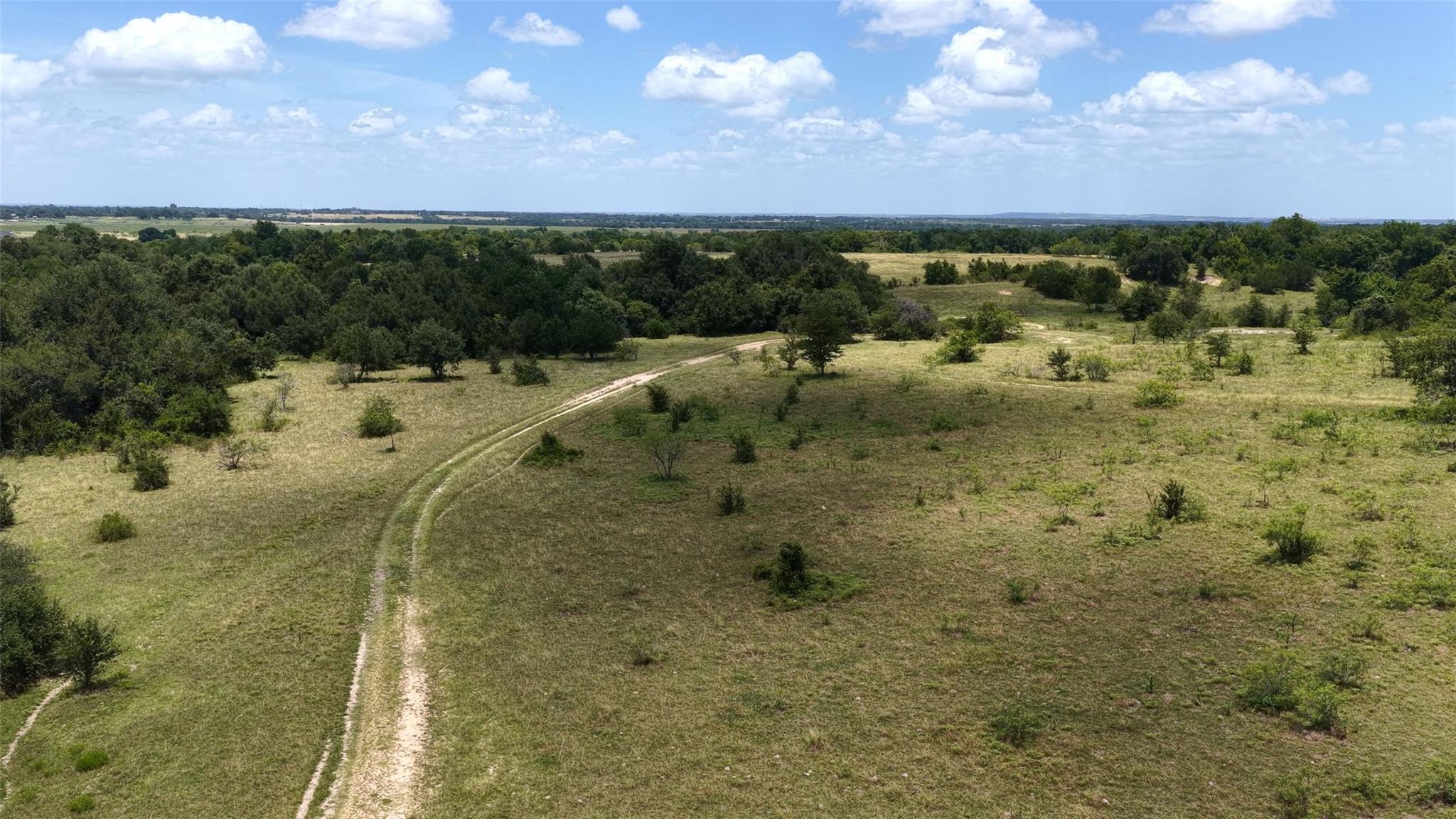 A rustic dirt path meanders through a sprawling, 