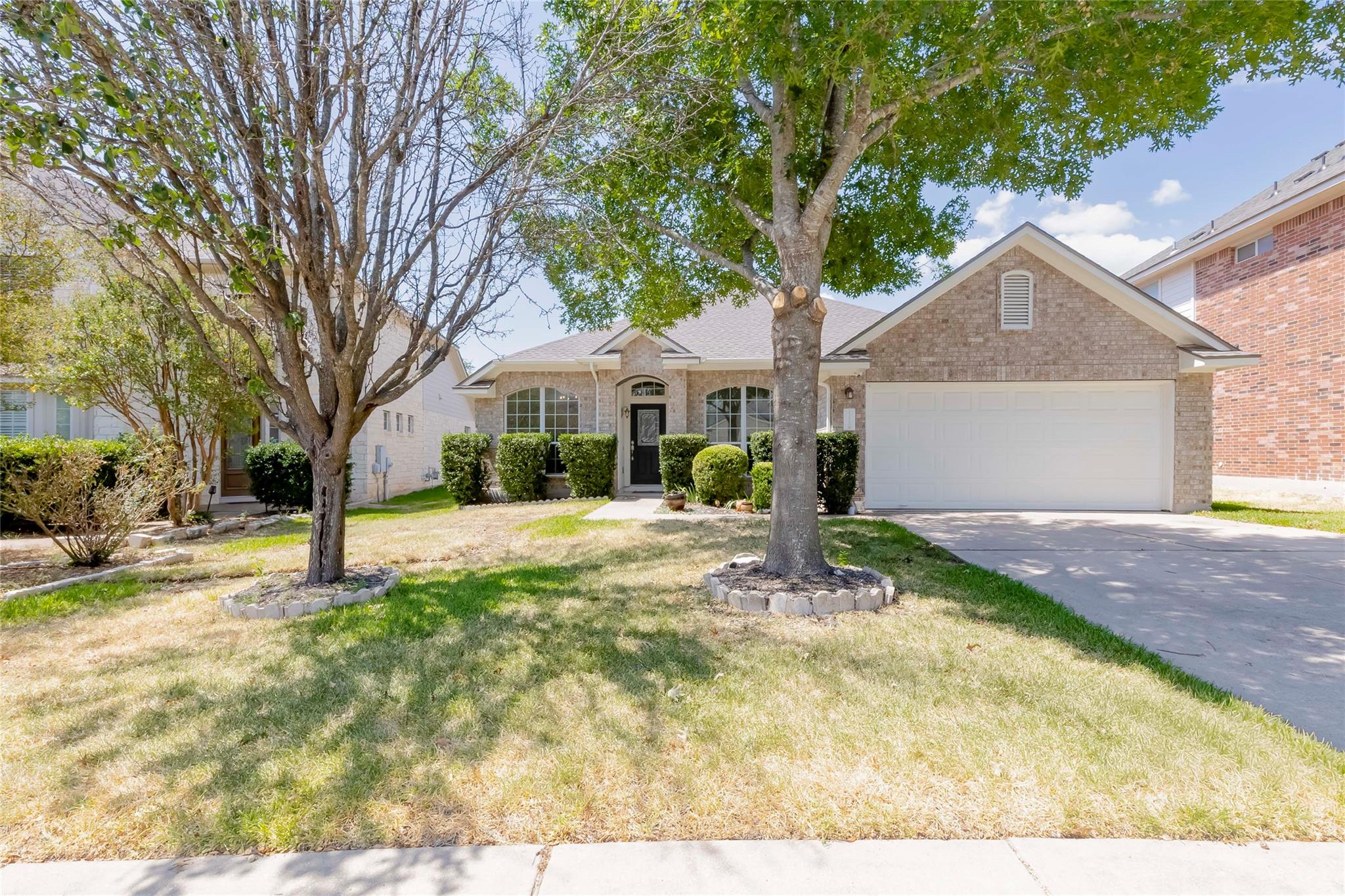 Mature trees shade the front lawn of this classic