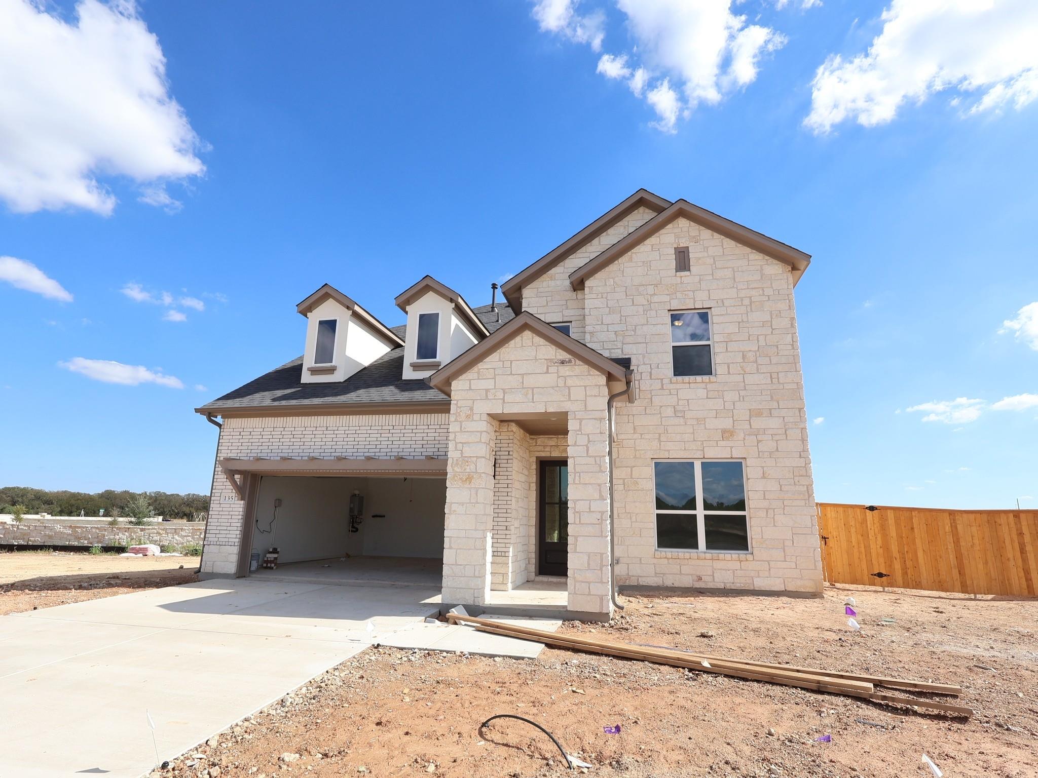Textured light stone masonry defines this newly c