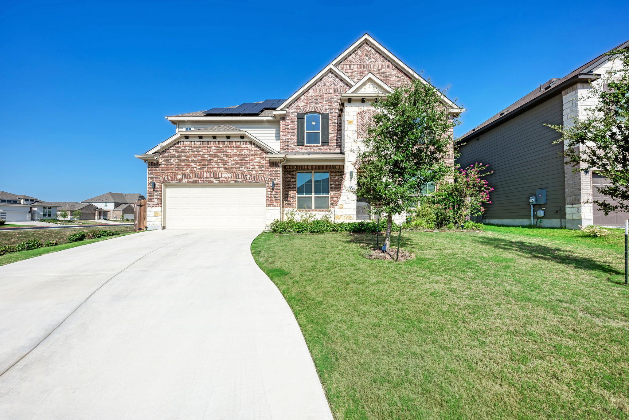 A well-maintained lawn and extended driveway gree