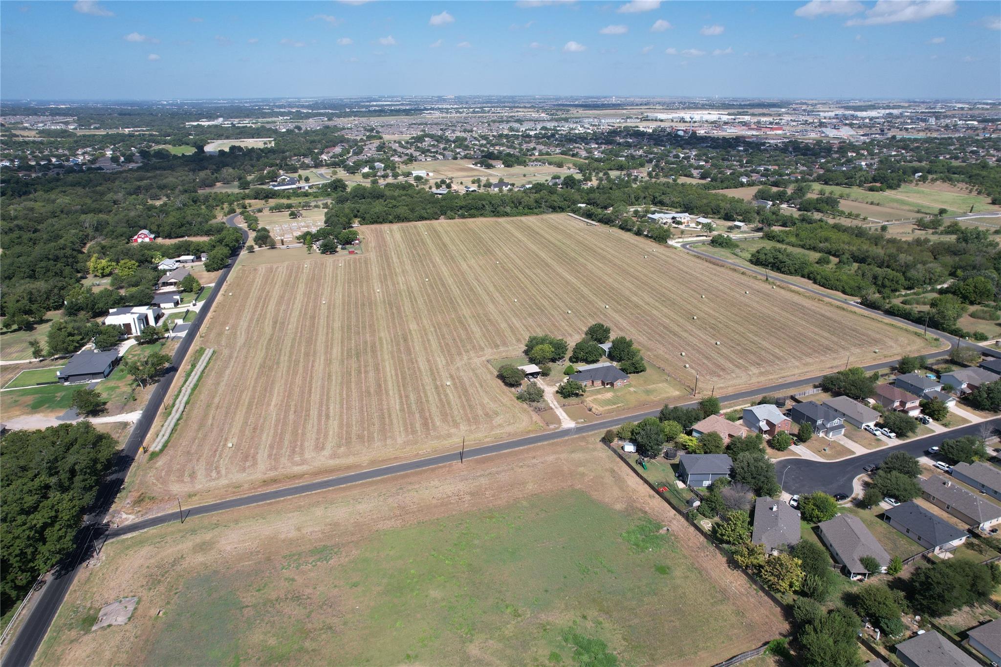 A vast agricultural tract spans the landscape nea