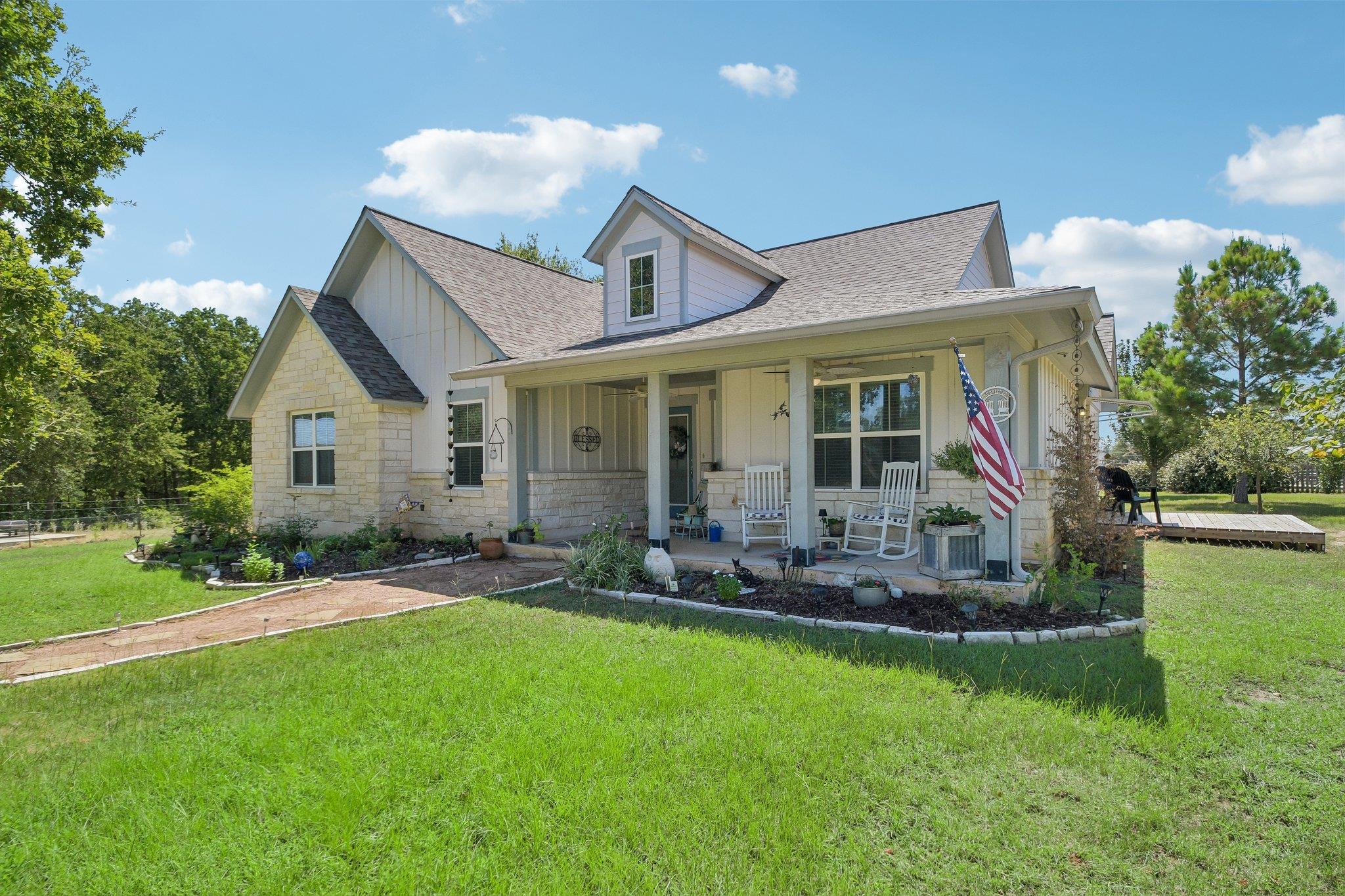 A welcoming front porch enhances the architectura