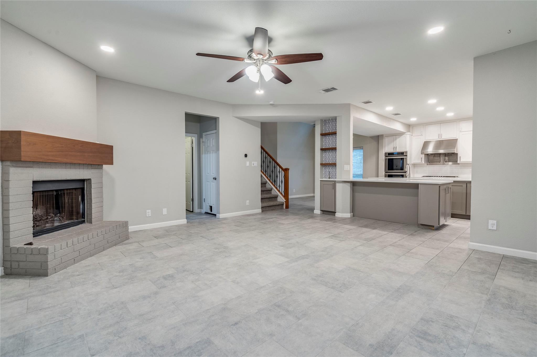 Smooth tile flooring and a classic brick fireplac
