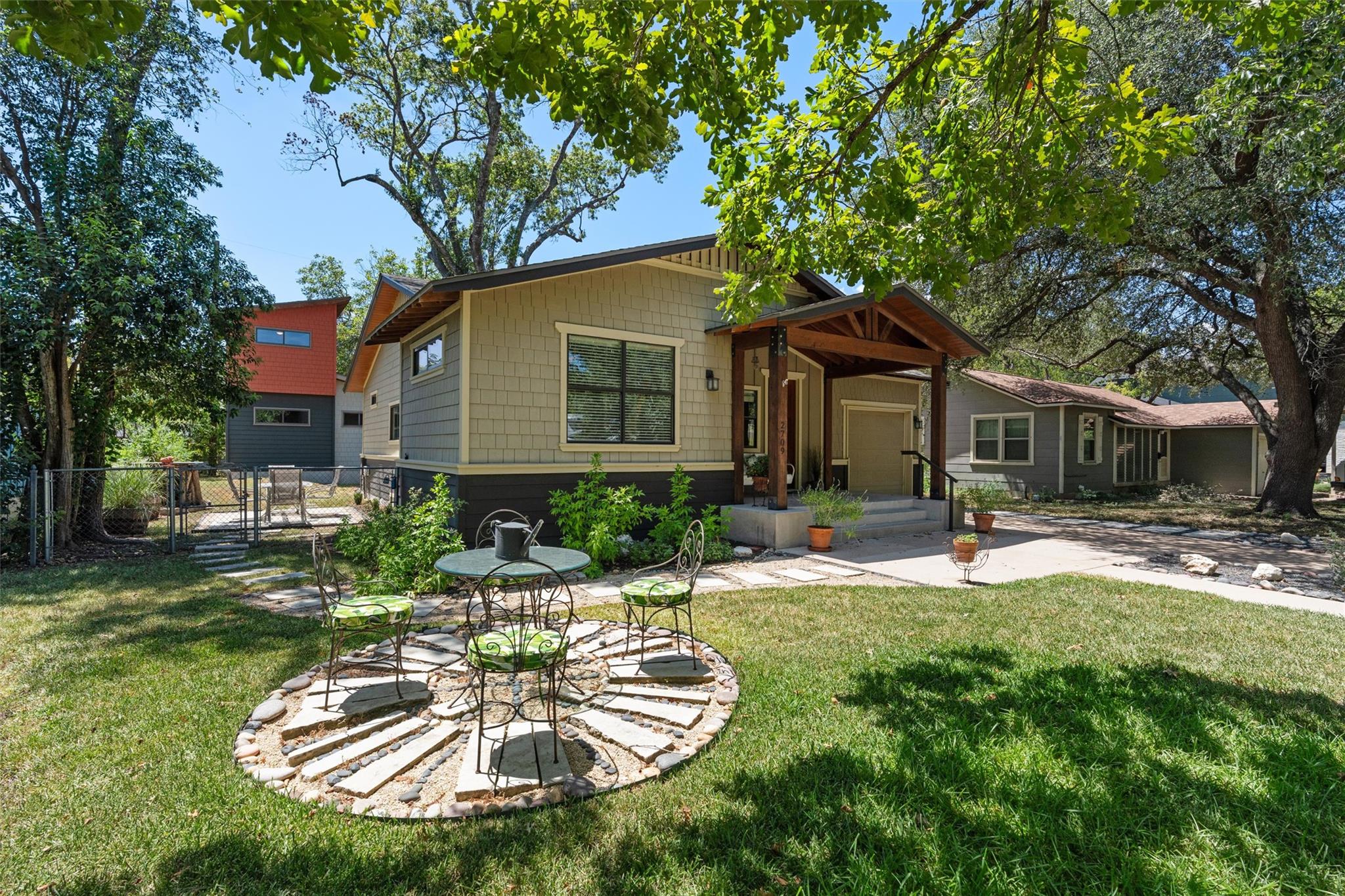 Mature trees shade a welcoming front porch and la