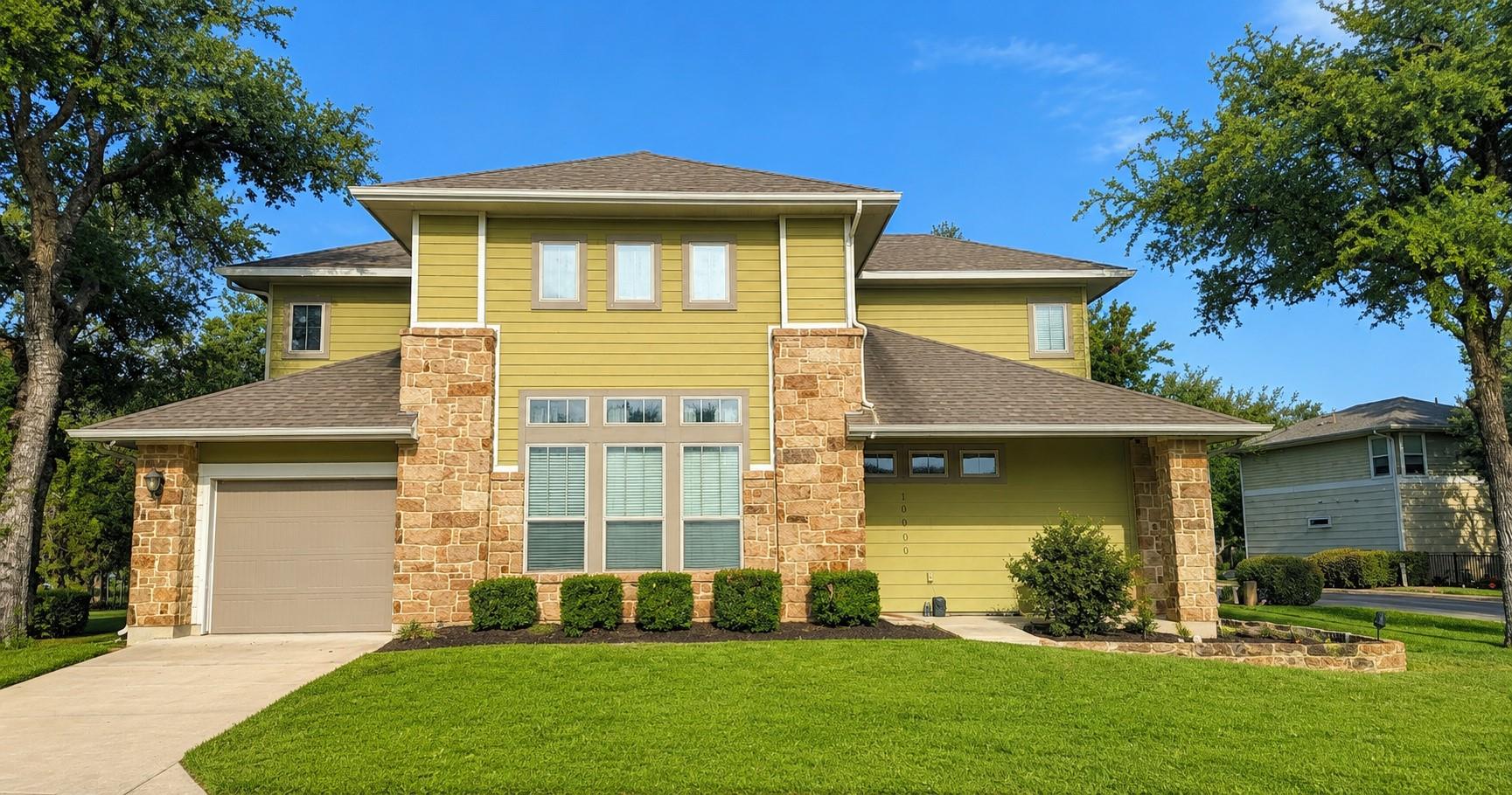 An inviting stone and siding facade defines this 