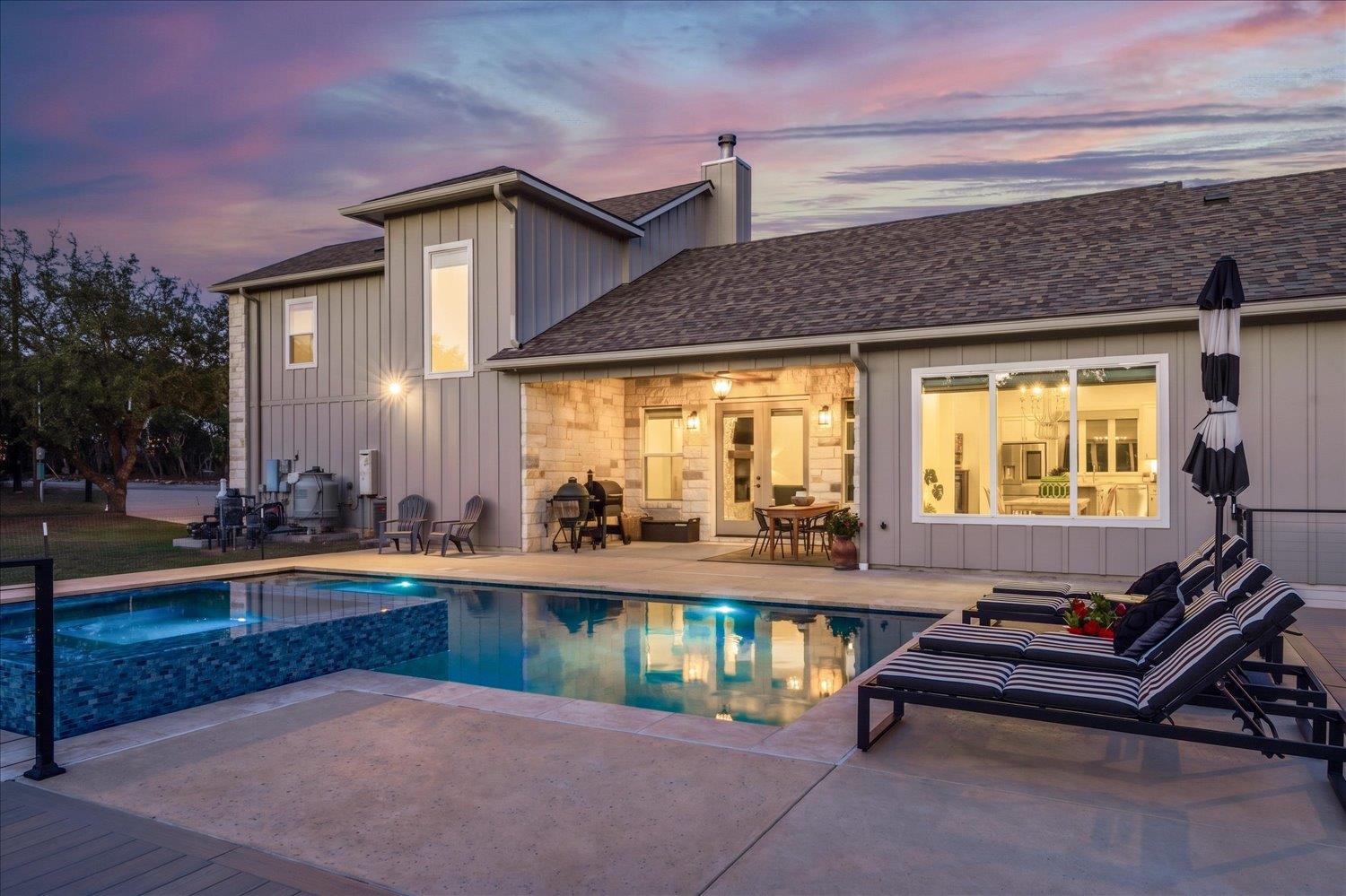 An inviting backyard oasis offers a sparkling poo