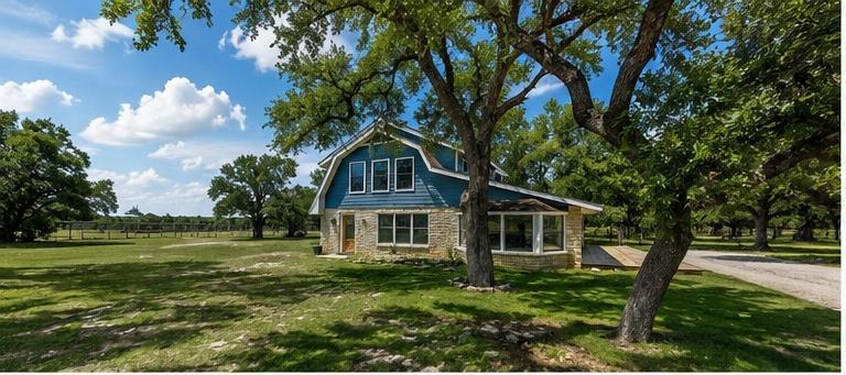 Mature trees shade a charming country home featur