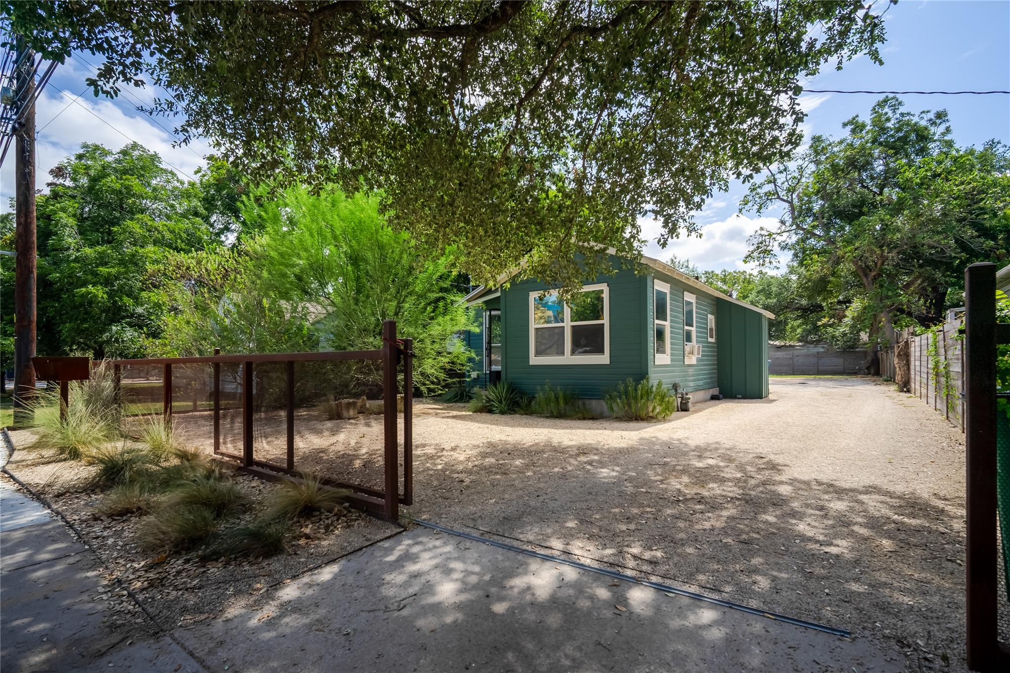 A quaint, jade-hued dwelling offers a generous gr