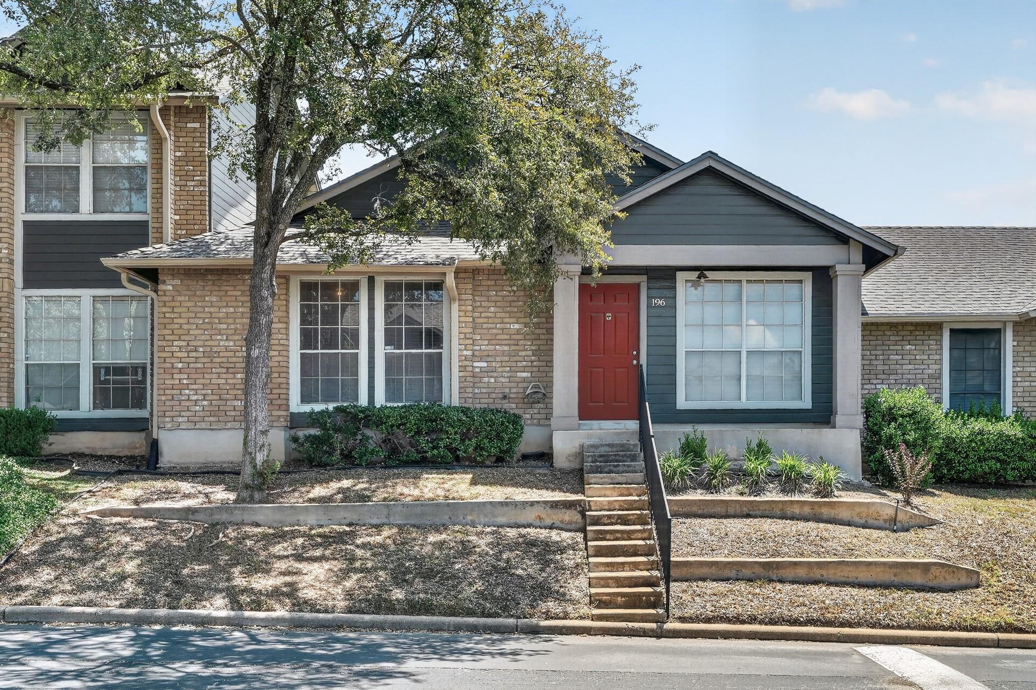 A welcoming brick and siding exterior with a vibr