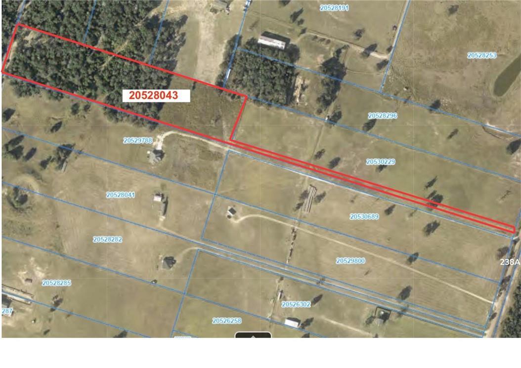 Aerial view displays a vast, undeveloped lot outl