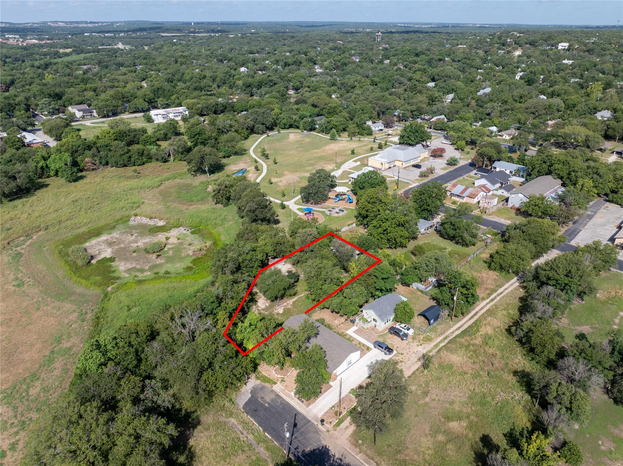 A spacious lot outlined in red, nestled amongst a