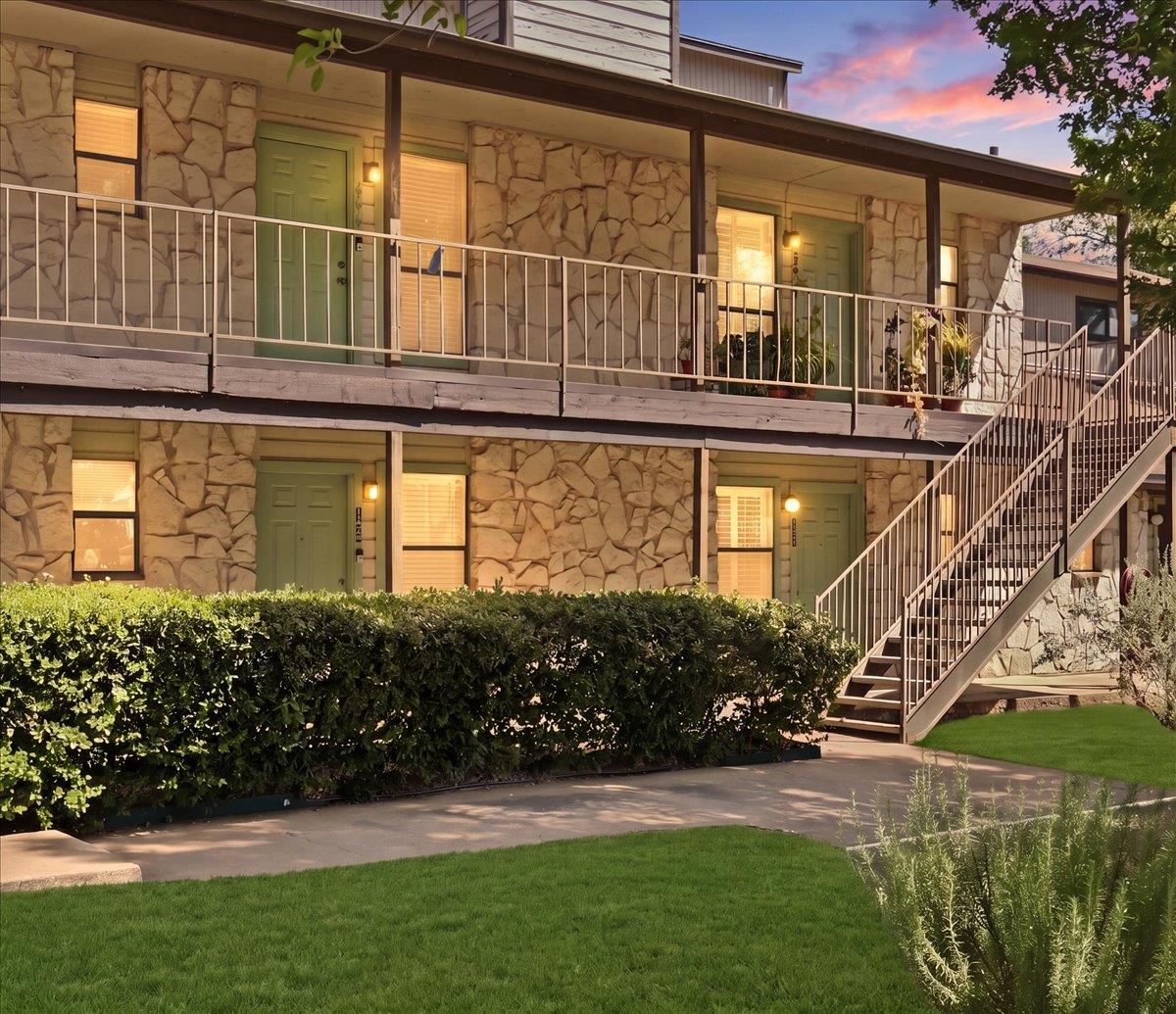 Textured stone siding and a metal staircase defin