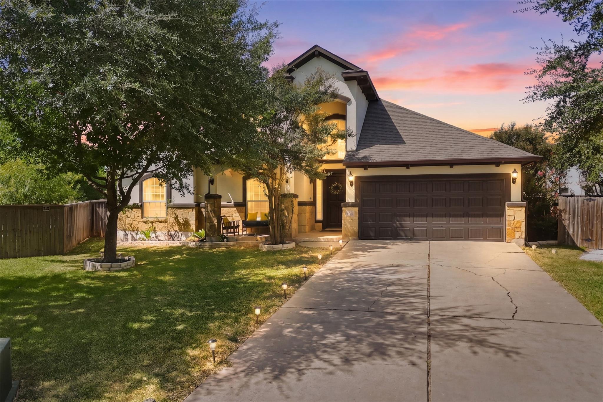 A welcoming stone-accented home with an inviting 