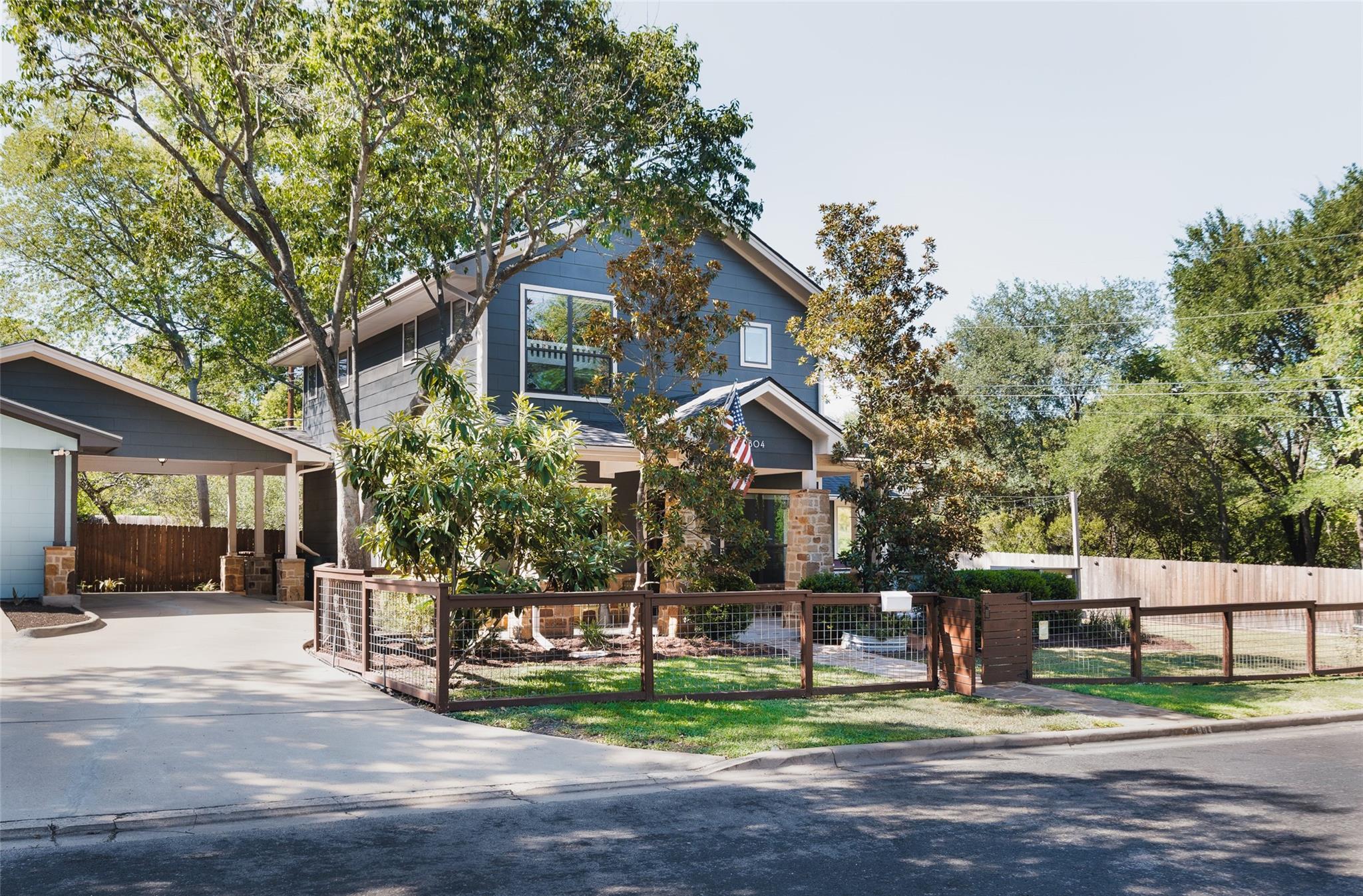 Mature trees frame a modern multi-level exterior 