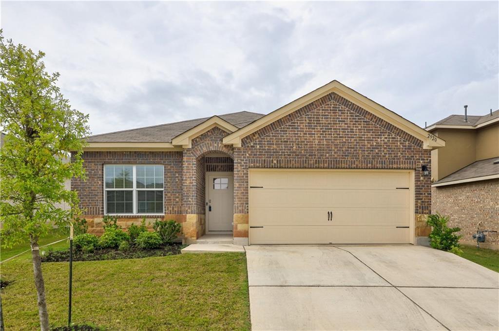 A classic brick exterior with stone accents provi