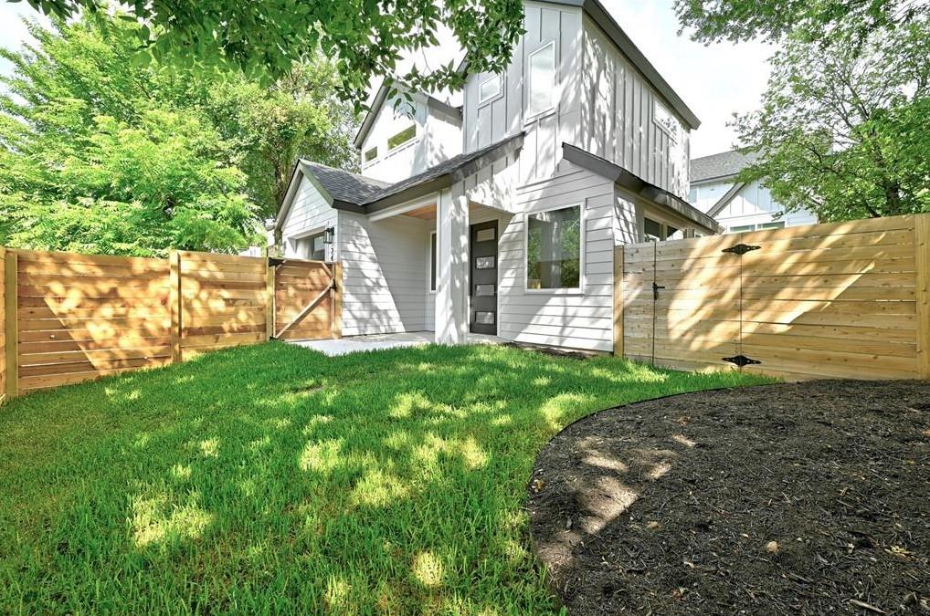 Modern vertical siding and a neat lawn frame this