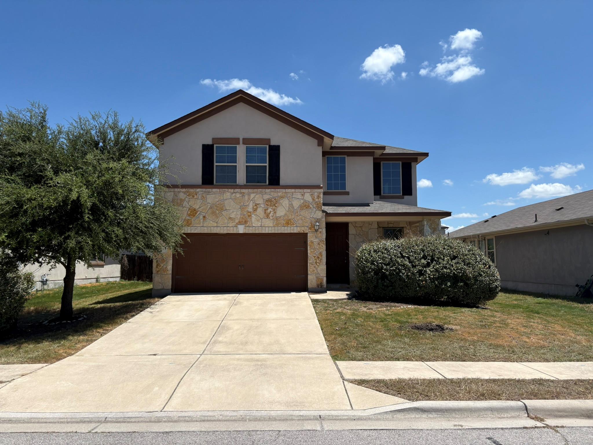 A classic two-story exterior showcases stone maso