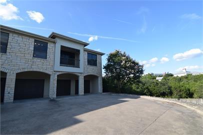 Stone facade and arched garage doors define this 