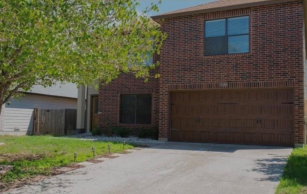 A classic brick exterior accents this two-story h