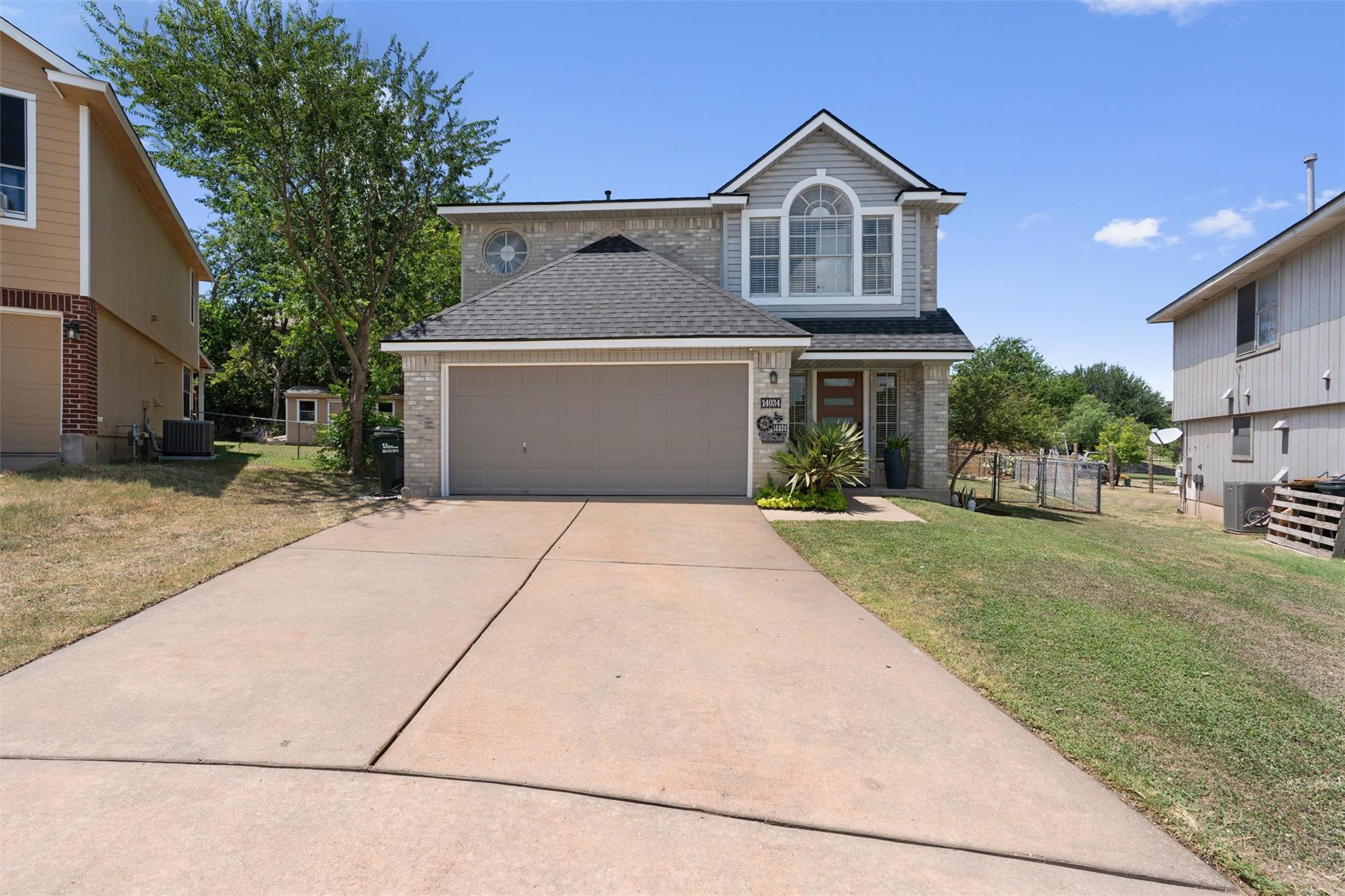 A classic brick and siding home presents a welcom