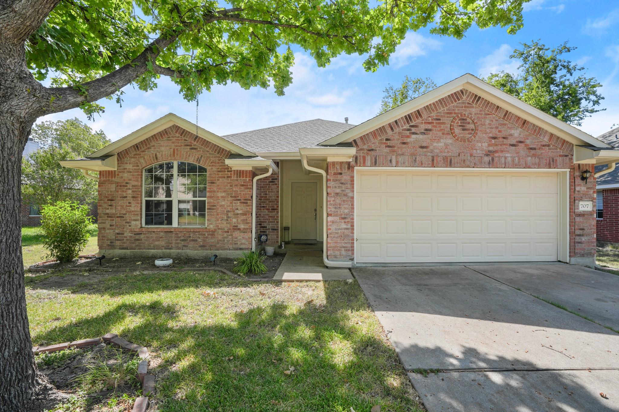 Classic brick accents and mature shade trees fram