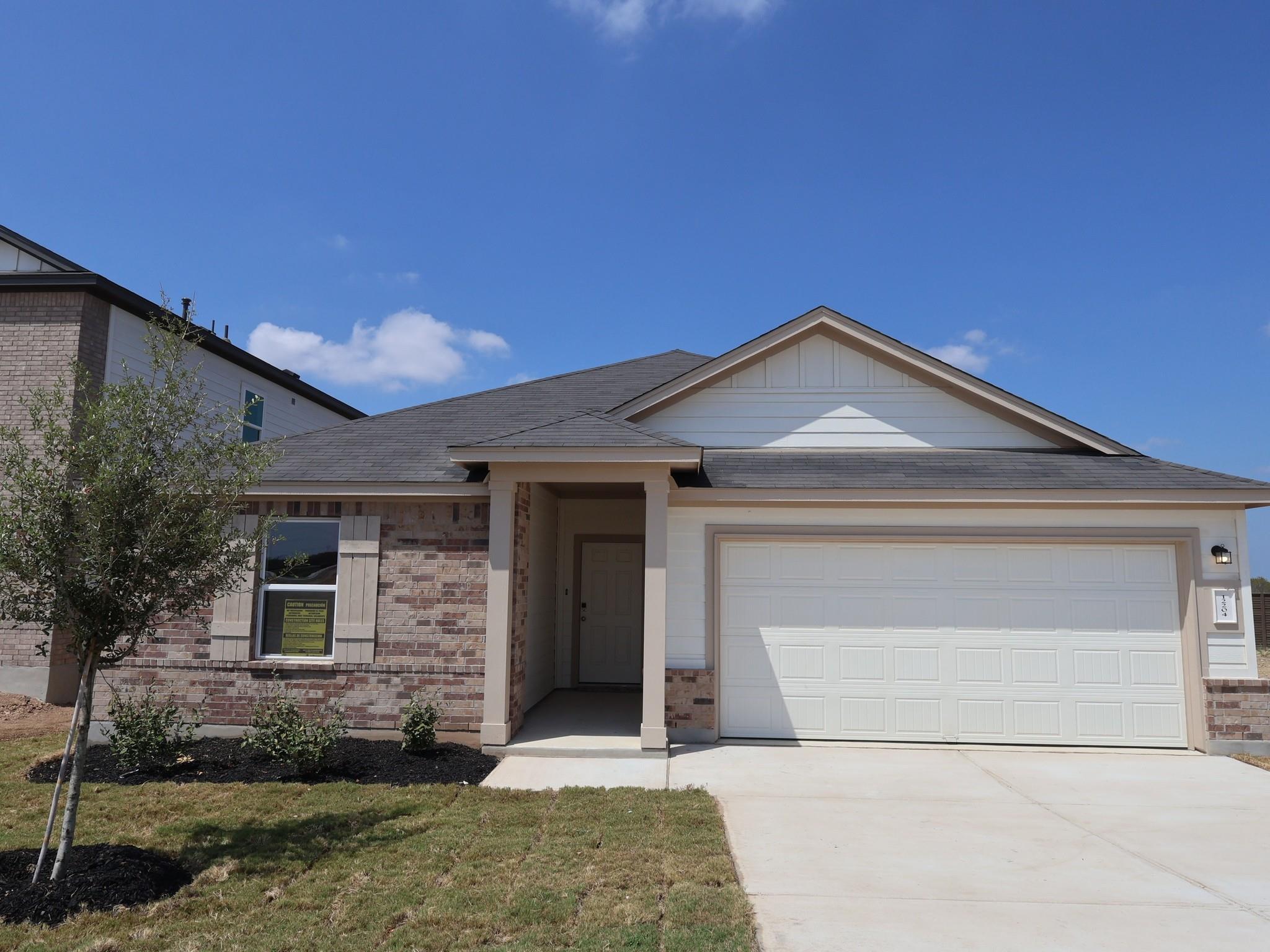 Brick and siding accents define the exterior faca