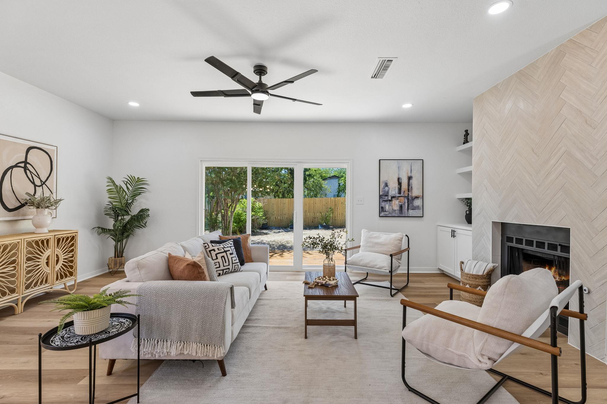 Sliding glass doors open to the backyard from thi