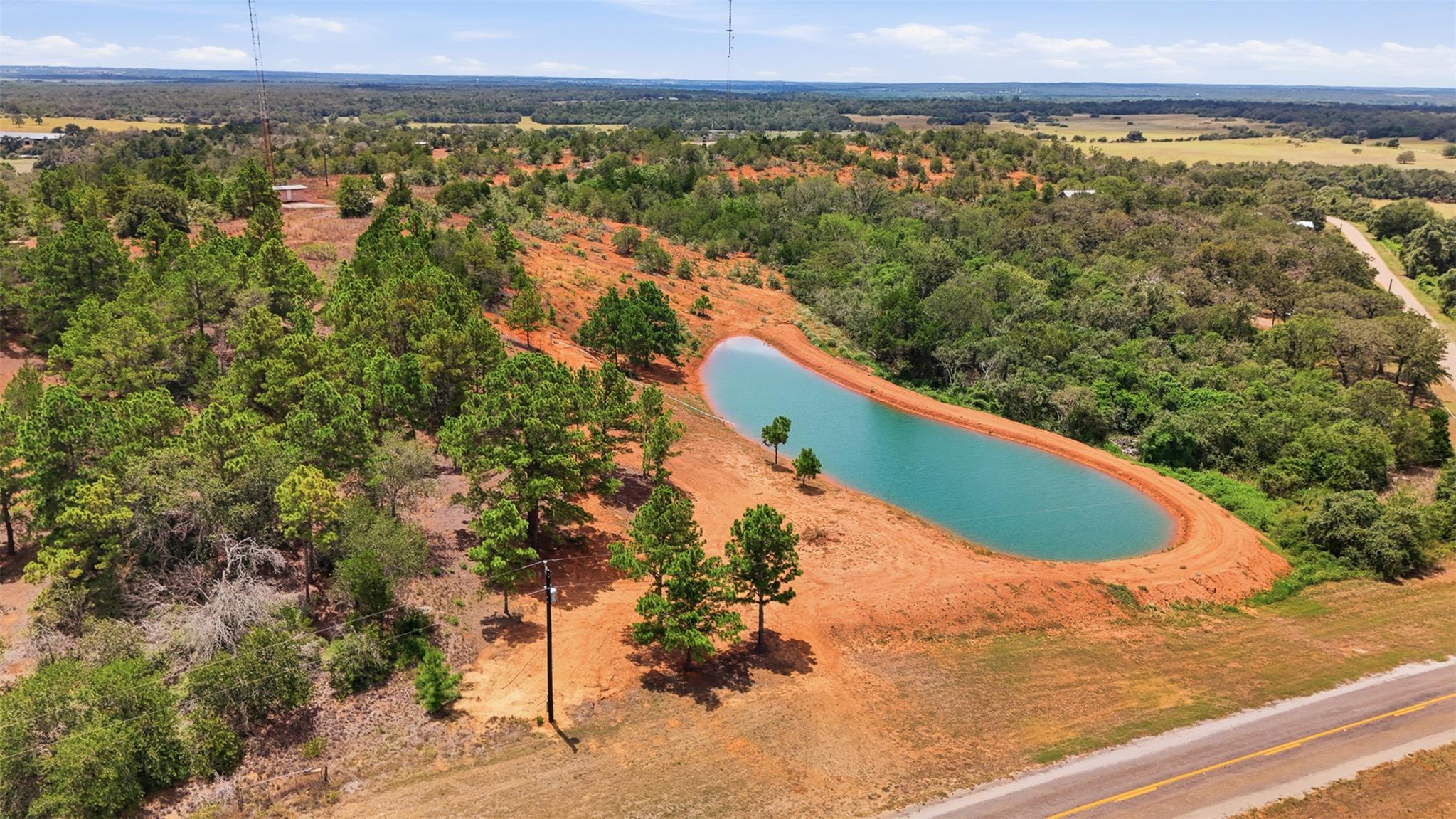 Vast acreage featuring a tranquil pond, mature tr