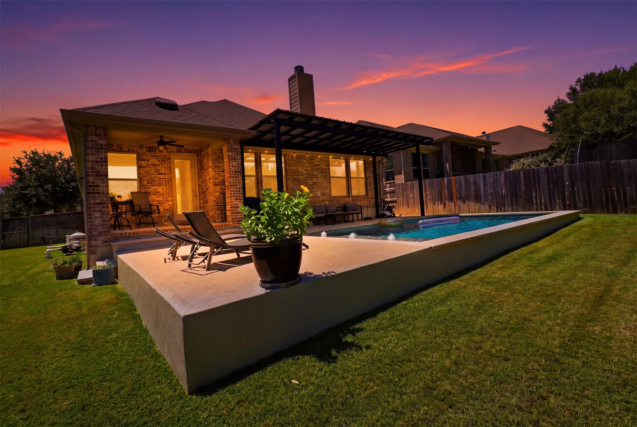 A spacious concrete patio surrounds an inviting s