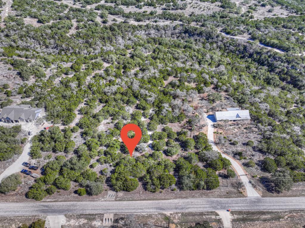 Mature trees surround this private acreage lot of