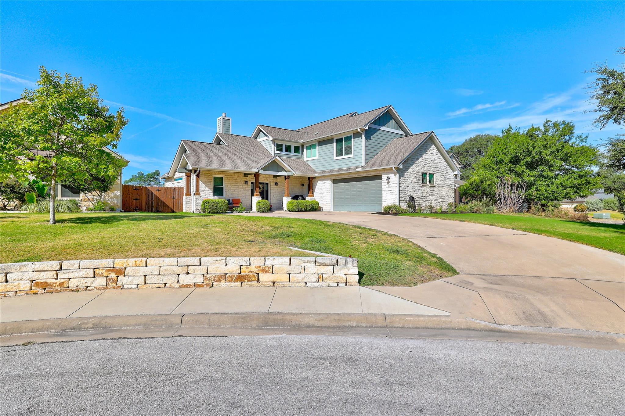 Limestone and wood siding accent the multi-level 