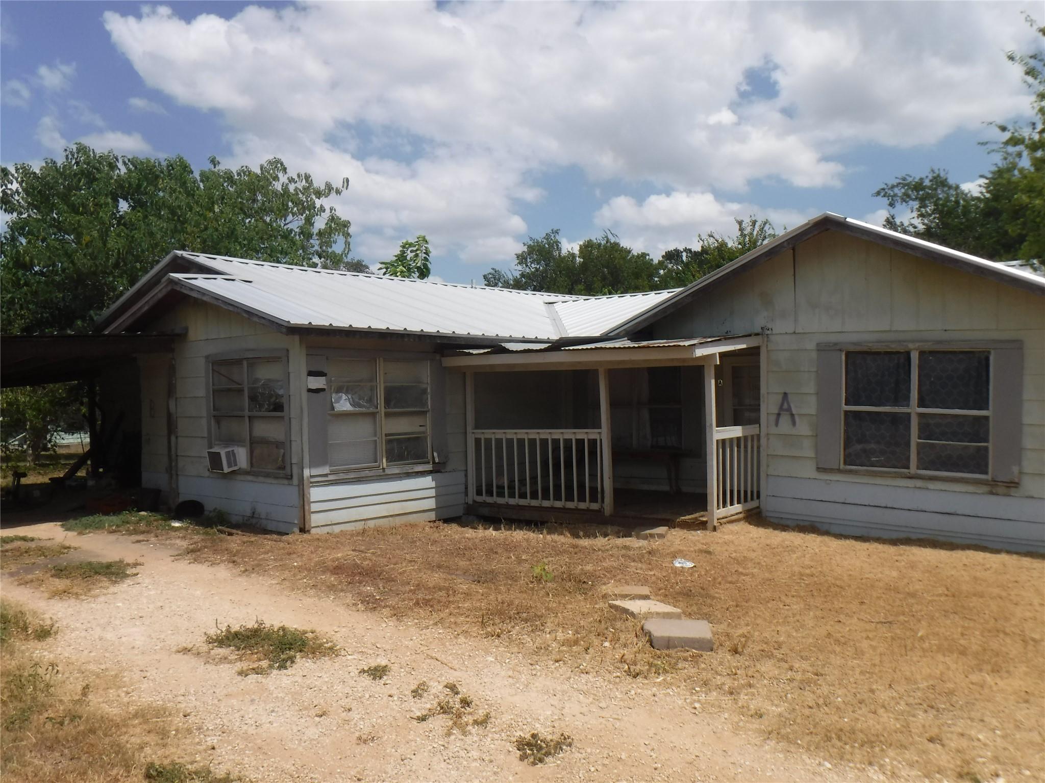 Metal roofing and a covered front porch define th